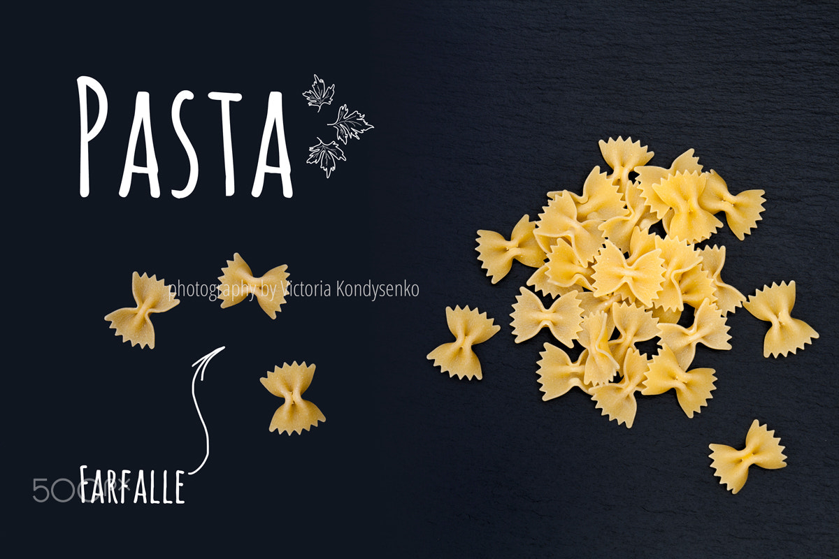 Canon EOS 1000D (EOS Digital Rebel XS / EOS Kiss F) + Canon EF-S 17-55mm F2.8 IS USM sample photo. Uncooked italian pasta farfalle on black slate stone background photography