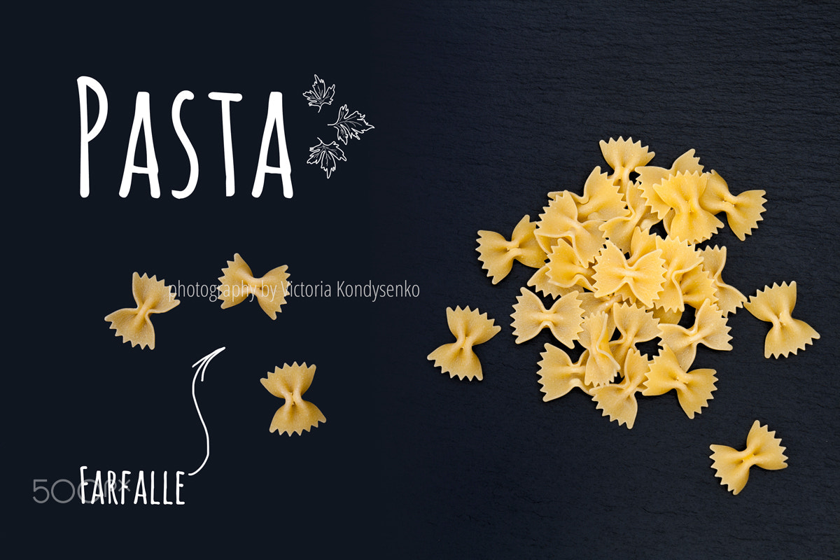 Canon EOS 1000D (EOS Digital Rebel XS / EOS Kiss F) sample photo. Uncooked italian pasta farfalle on black slate stone background photography