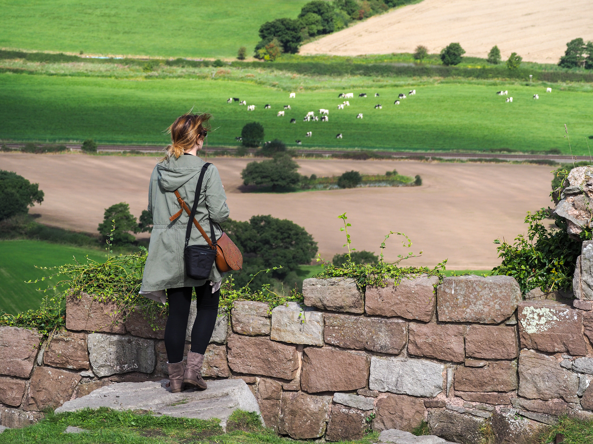 Olympus PEN-F + Olympus M.Zuiko ED 75-300mm F4.8-6.7 II sample photo. Woman looking at the cheshire countryside from beeston castle photography