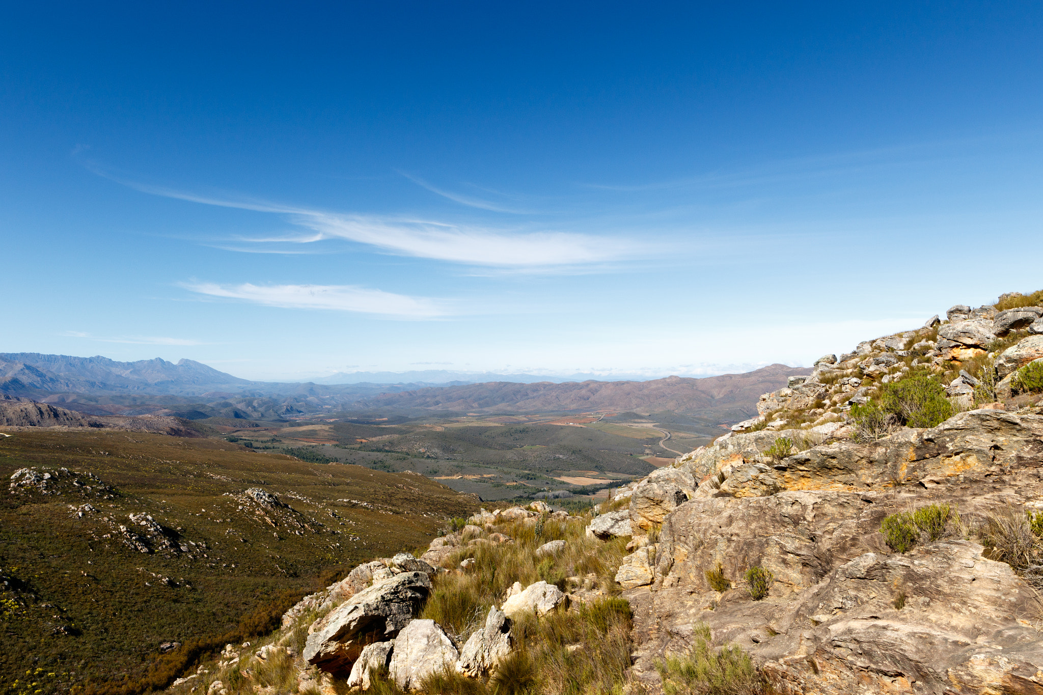Canon EF 300mm f/2.8L sample photo. Green valley surrounded by mountains with clouds photography