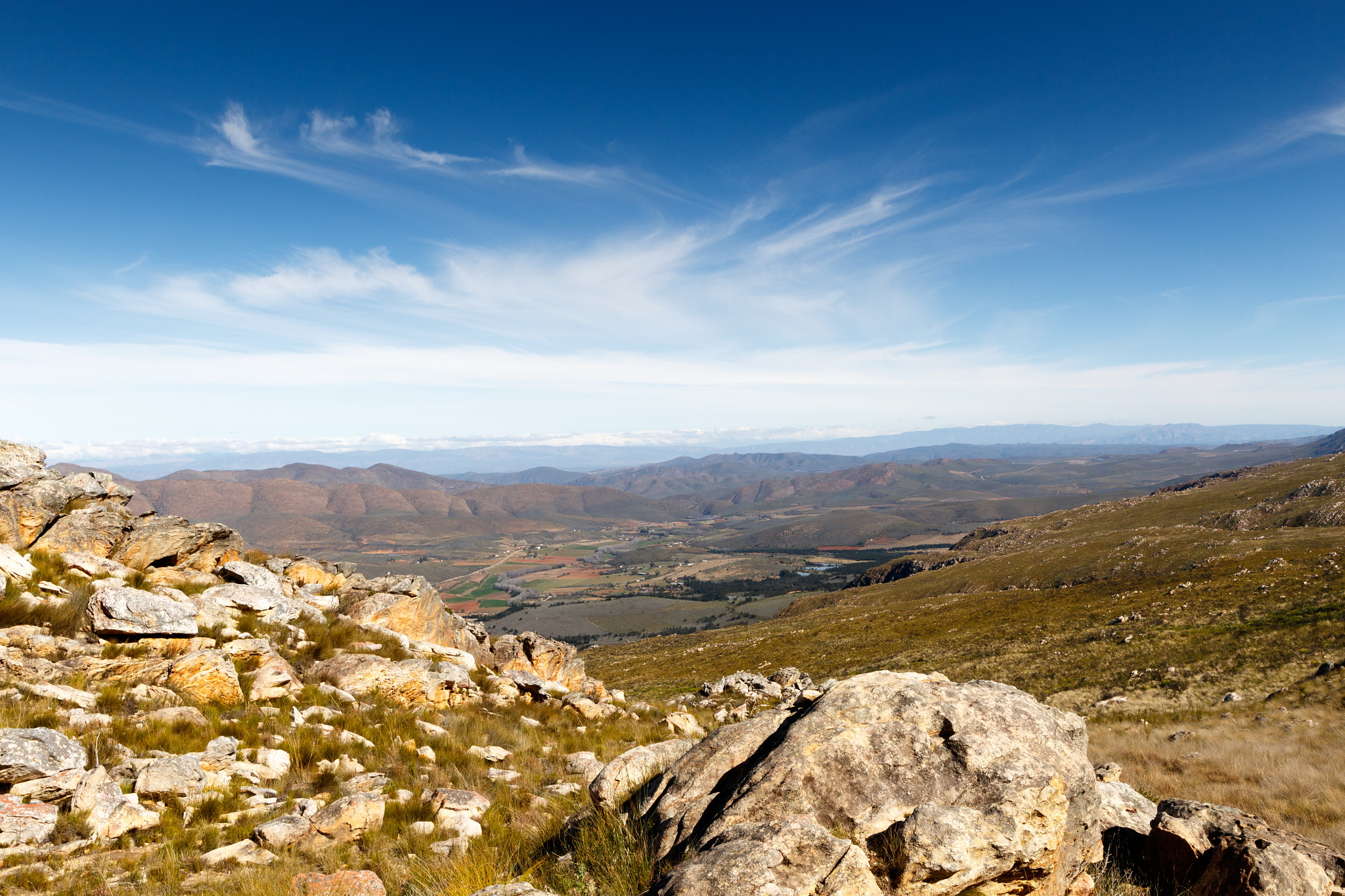 Canon EF 300mm f/2.8L sample photo. Green valley surrounded by mountains looking onto a plato photography