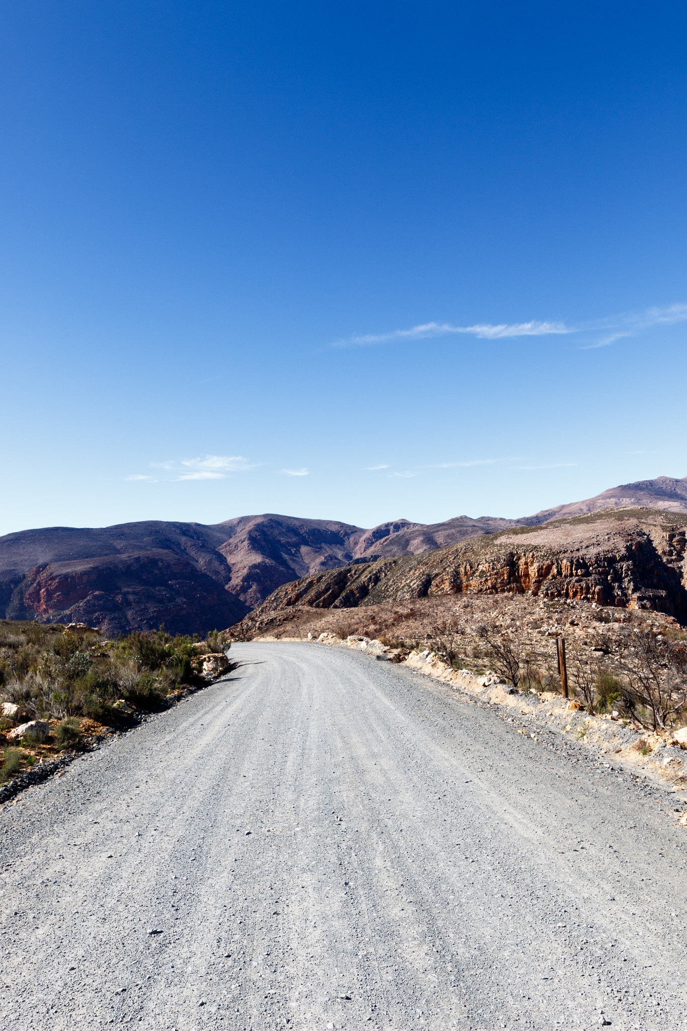 Canon EOS 7D Mark II sample photo. Gravel road leading to the mountains photography
