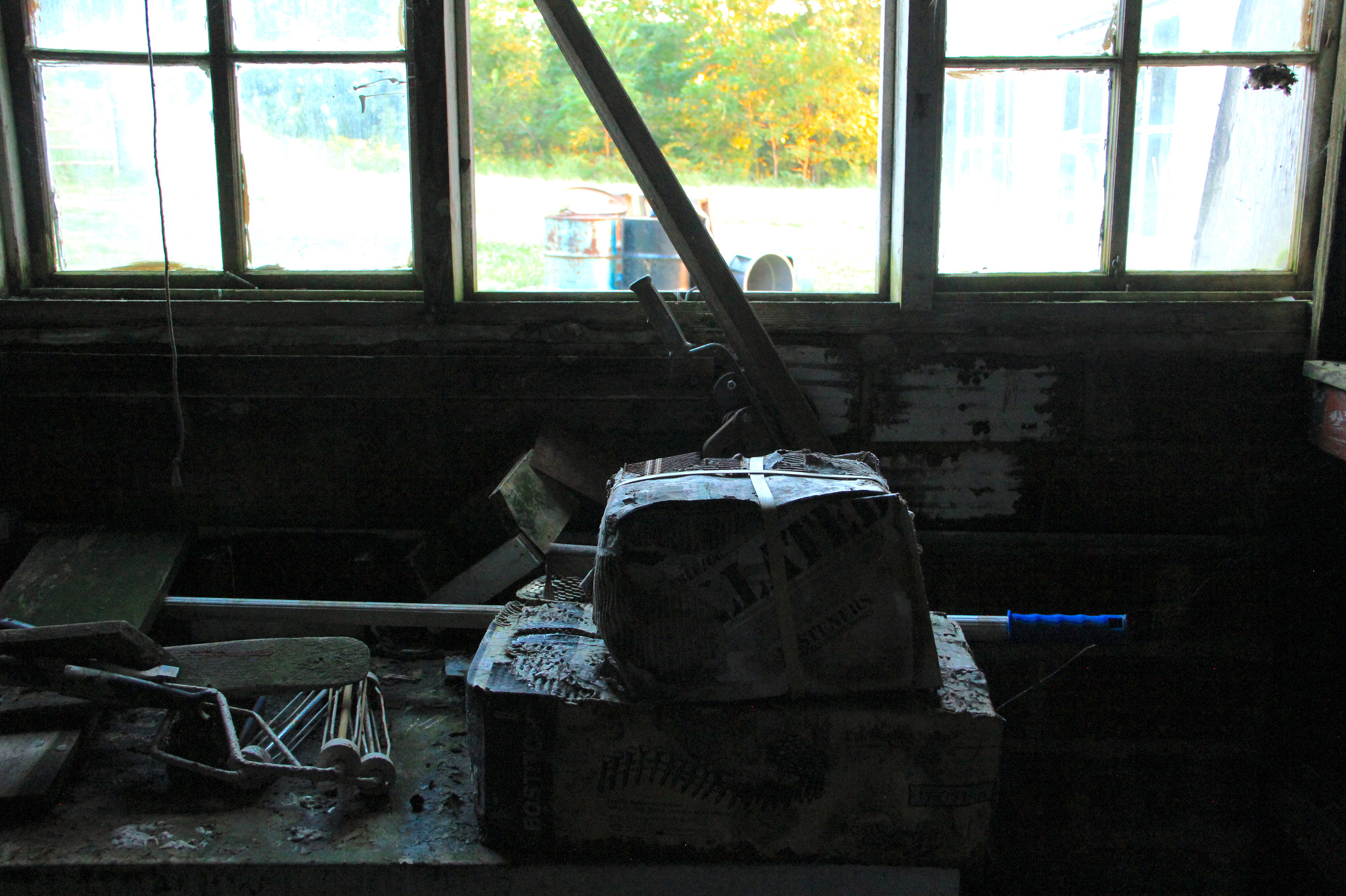 Canon EF-S 18-135mm F3.5-5.6 IS sample photo. Abandoned packages in a workshop window photography