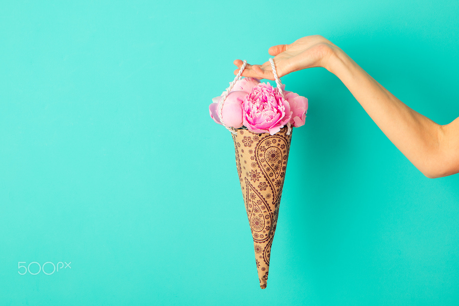 Canon EOS 5DS + Canon EF 24-70mm F2.8L USM sample photo. Bunch of peonies flowers in female hand on a turquoise wall background. copy space photography