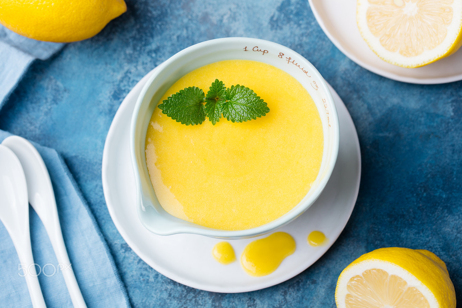 Canon EOS 5DS + Canon EF 100mm F2.8L Macro IS USM sample photo. Lemon curd in ceramic bowl with fresh lemons on a blue napkin background. top view. selective focus photography