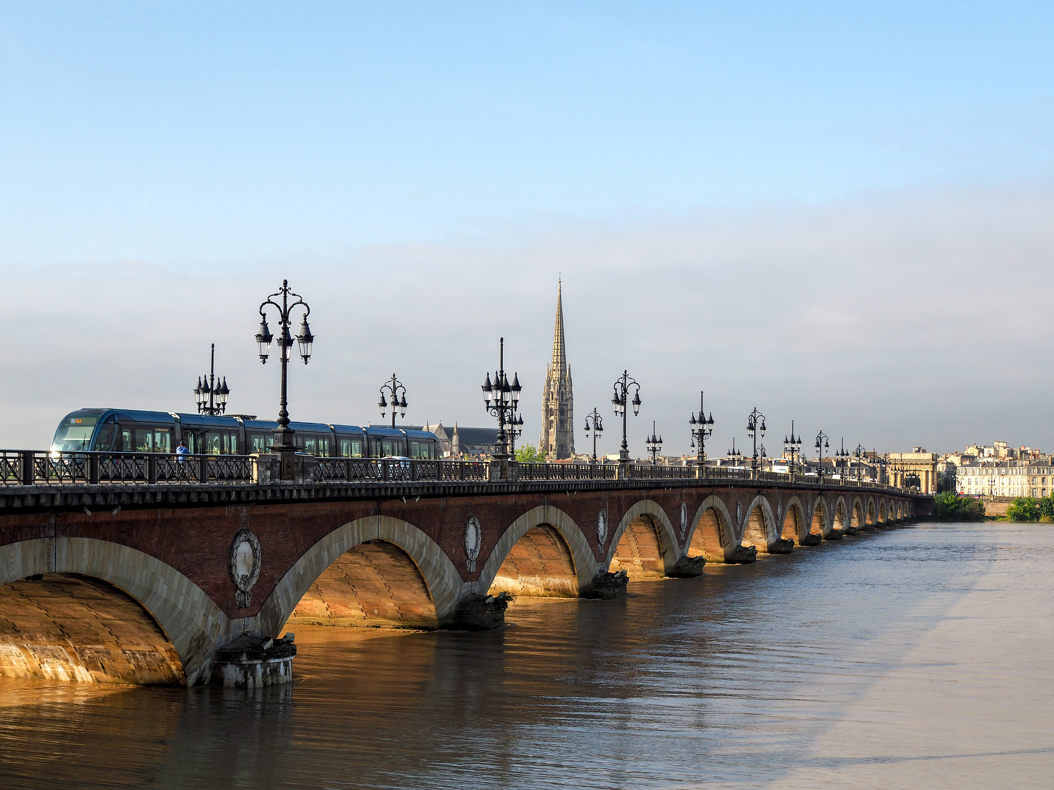 Olympus PEN-F + Olympus M.Zuiko Digital 25mm F1.8 sample photo. Tram passing over the pont de pierre spanning the river garonne photography