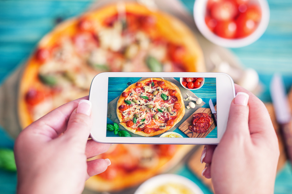 Young woman taking a photo of Pizza by Igor Jovanovic on 500px.com