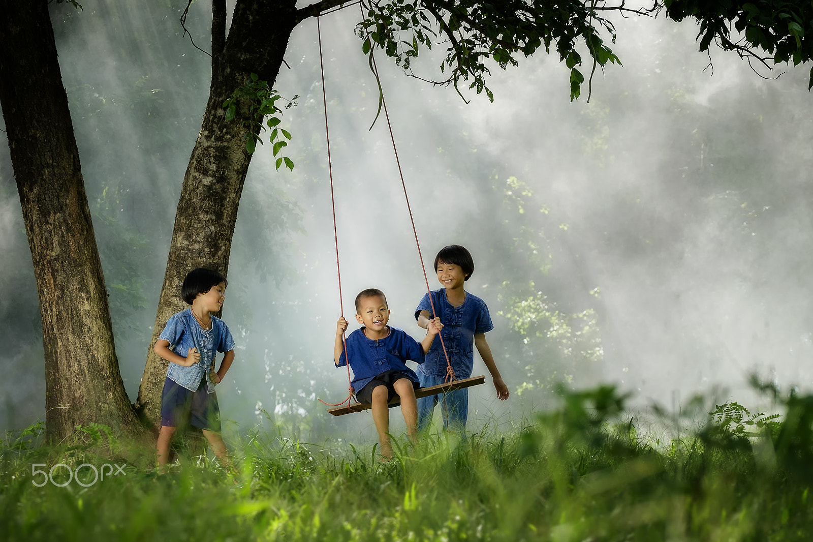 Fujifilm X-E2 + Fujifilm XF 50-140mm F2.8 R LM OIS WR sample photo. Three asian children playing swing under the tree in leisure time photography