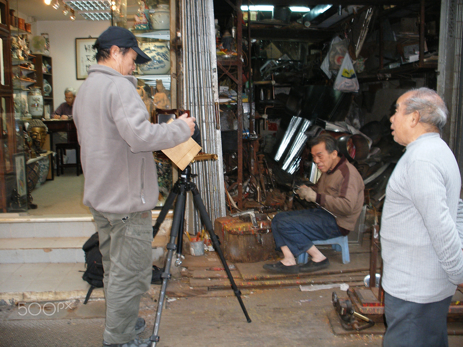 Fujifilm FinePix F650 sample photo. Photographer taking picture of artisan making item photography