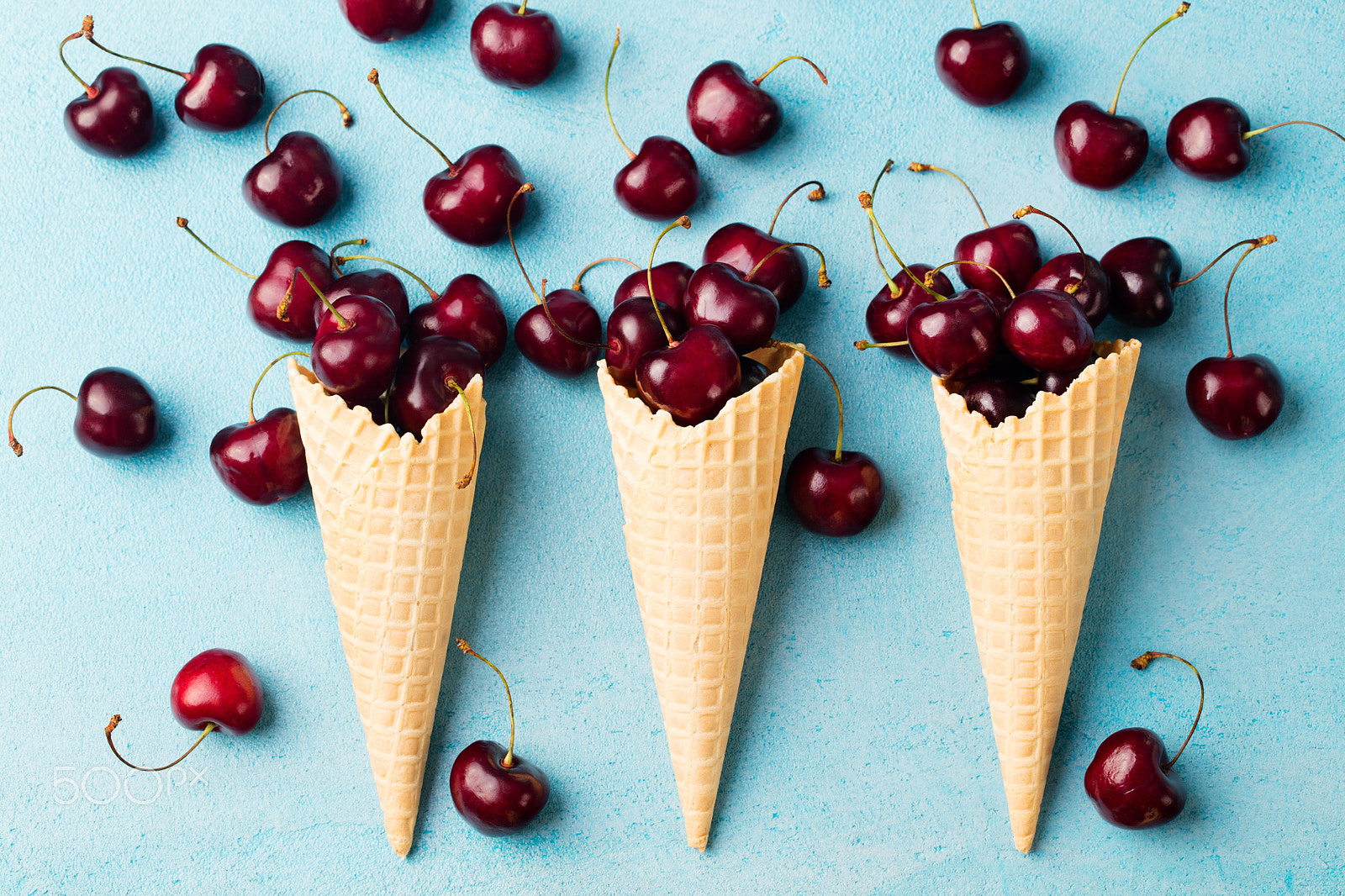 Canon EOS 5DS + Canon EF 100mm F2.8L Macro IS USM sample photo. Fresh black cherries in waffle cones on blue stone background top view photography