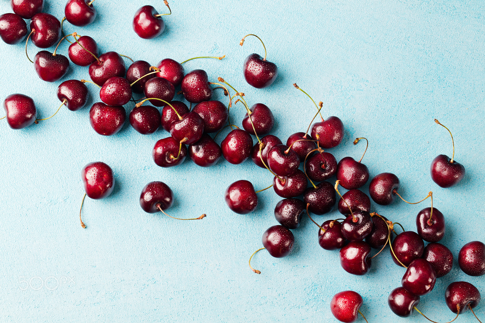 Canon EOS 5DS + Canon EF 100mm F2.8L Macro IS USM sample photo. Fresh ripe black cherries on a blue stone background top view copy space photography