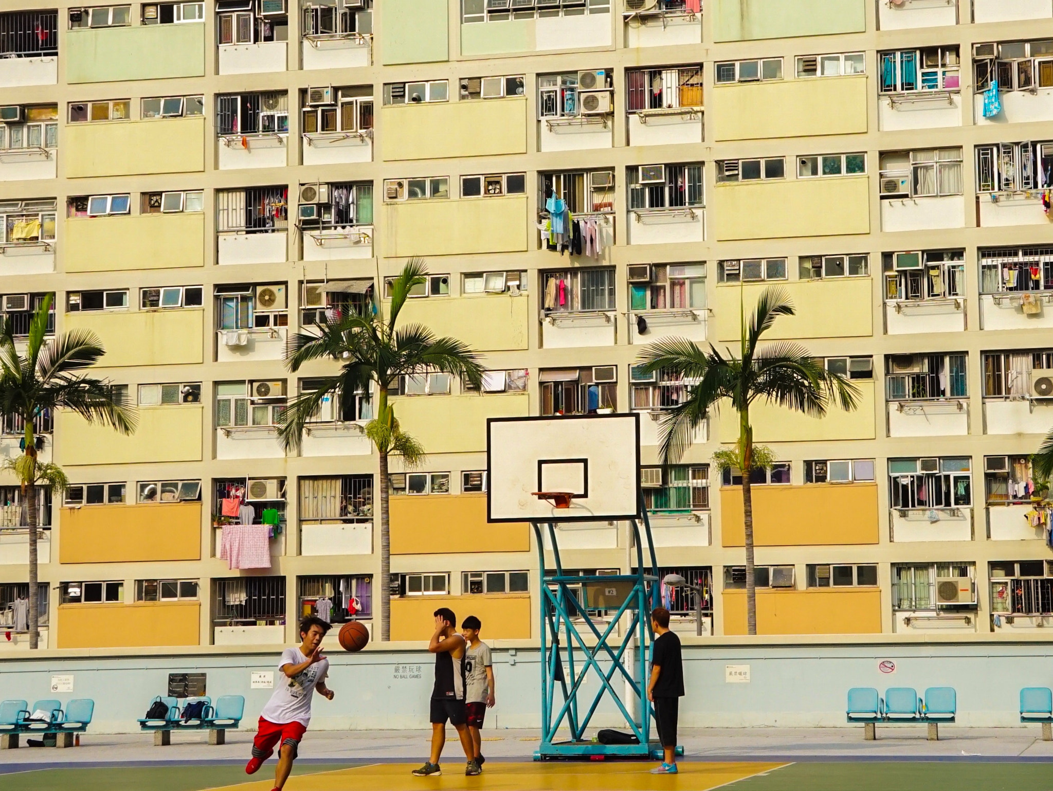 Sony E 18-200mm F3.5-6.3 OSS sample photo. Teenagers story with rainbow building photography