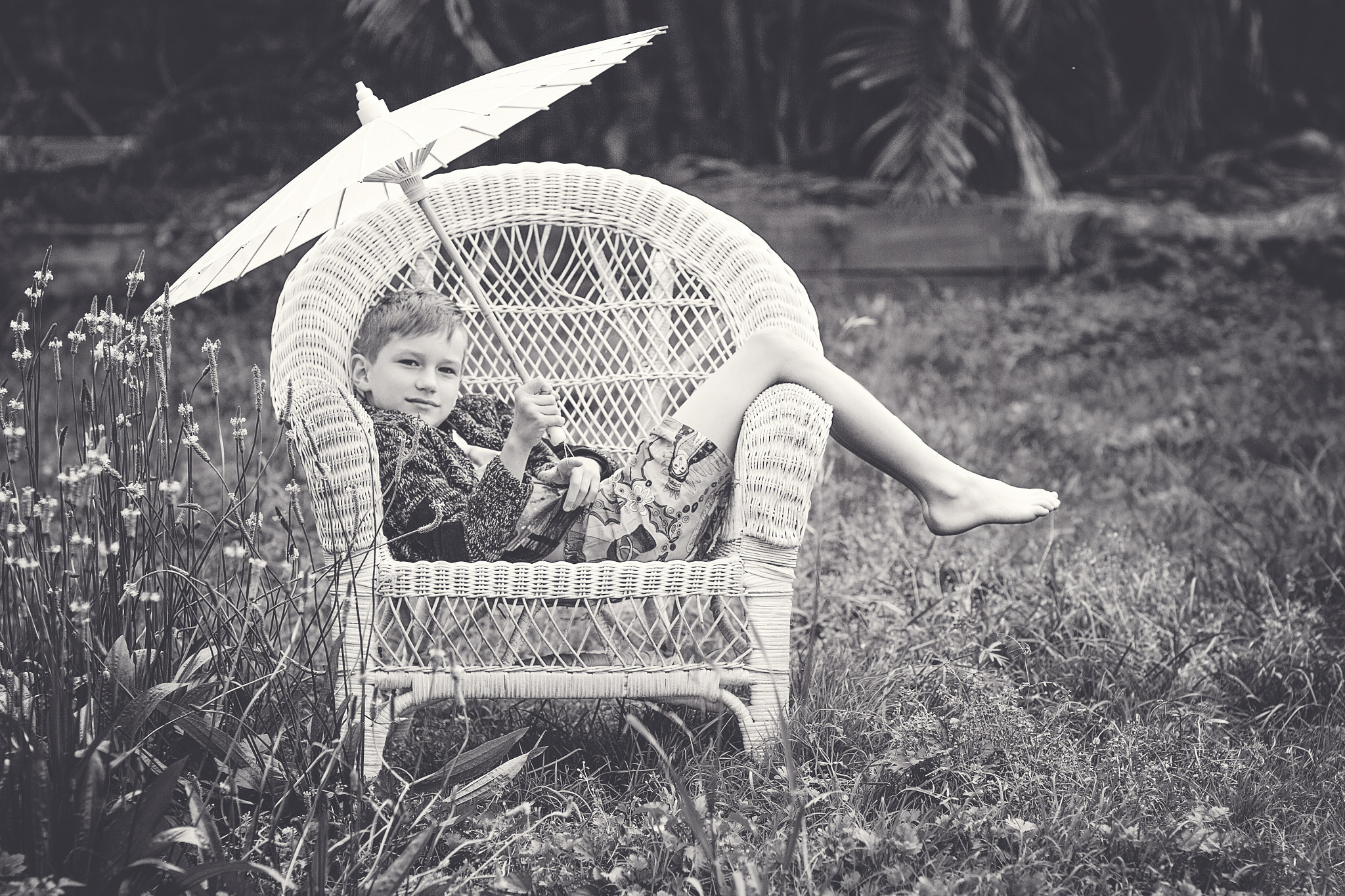 Canon EOS 7D + Canon EF 85mm F1.2L II USM sample photo. Boy, parasol. and a big cane chair. photography