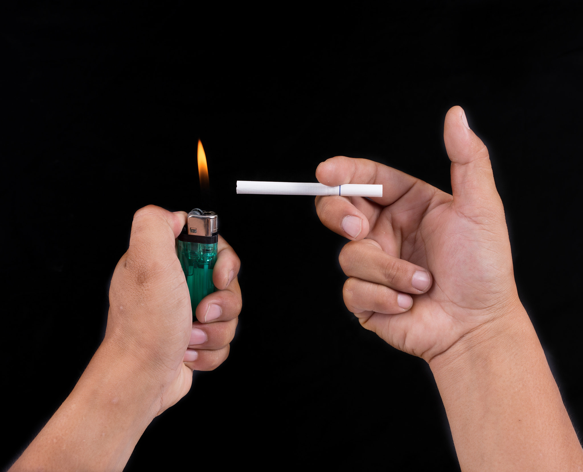 Canon EOS 6D + ZEISS Milvus 50mm F1.4 sample photo. Man lighting cigarette on black background photography