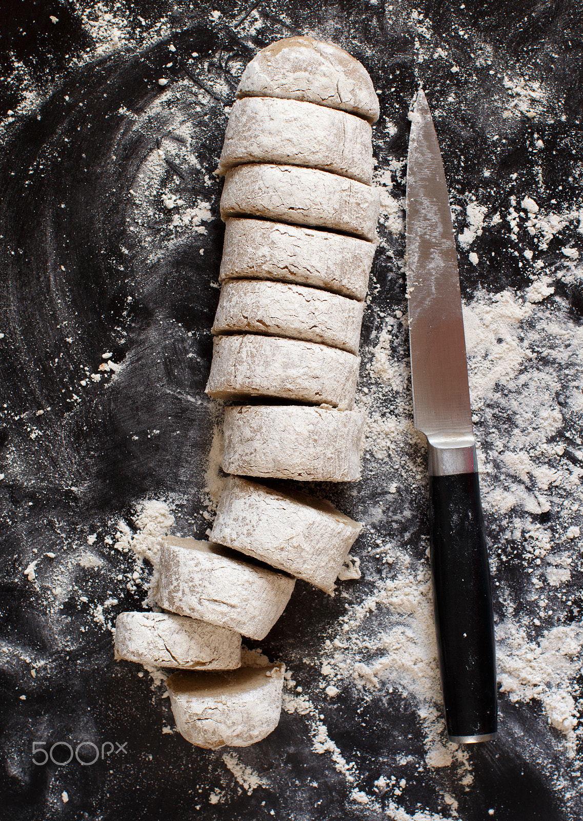 Canon EOS 650D (EOS Rebel T4i / EOS Kiss X6i) + Canon EF 50mm F1.2L USM sample photo. Pieces of raw dough with a knife photography