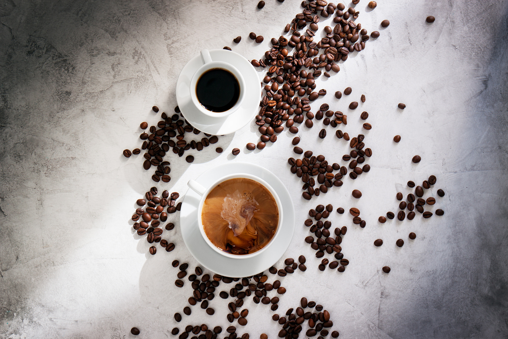 Canon EF 24-70mm F4L IS USM sample photo. Cups of coffee with coffee beans, sun light on a marble background, top view with copy space photography