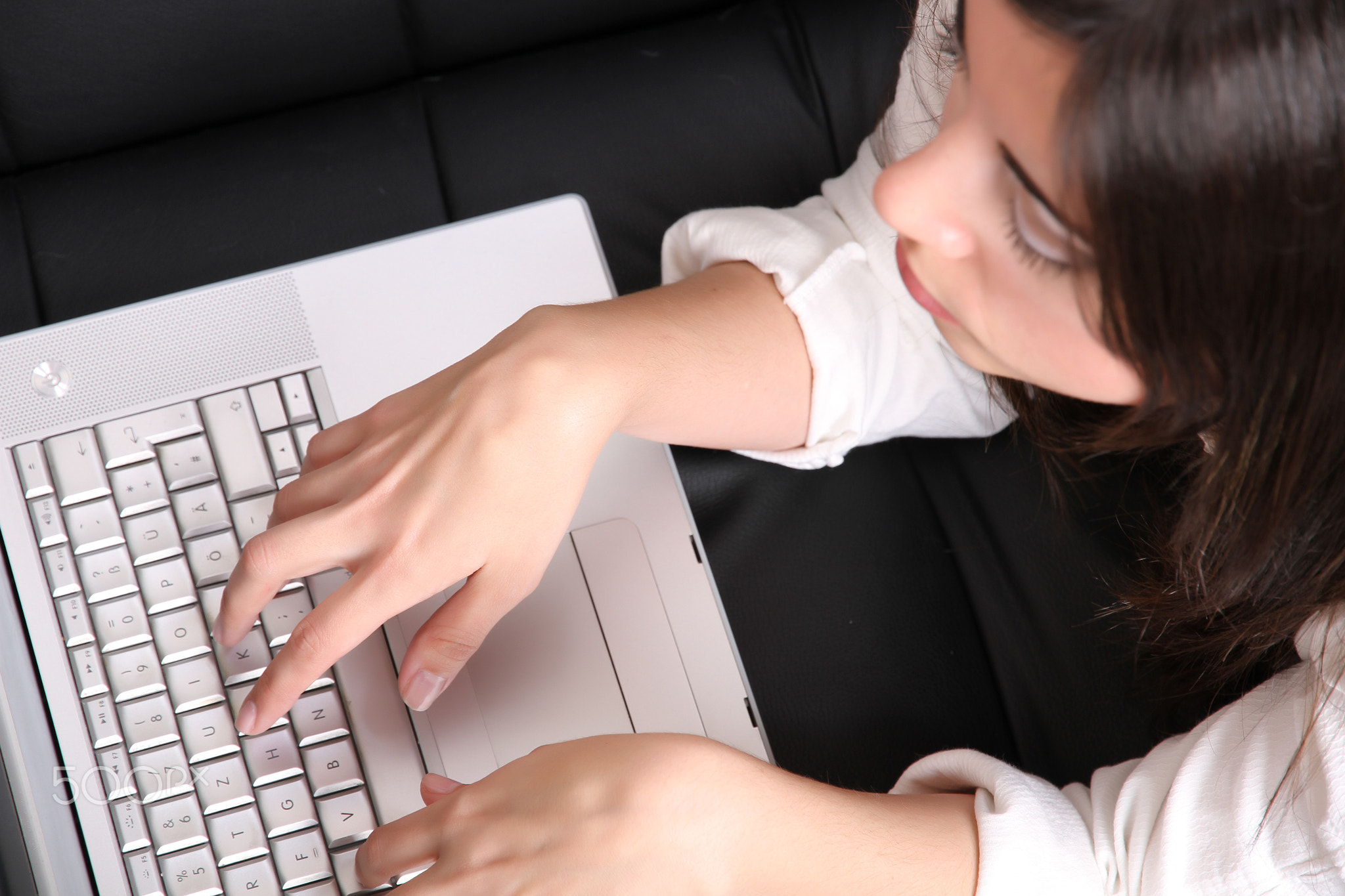 Young Hispanic Woman surfing on the Sofa