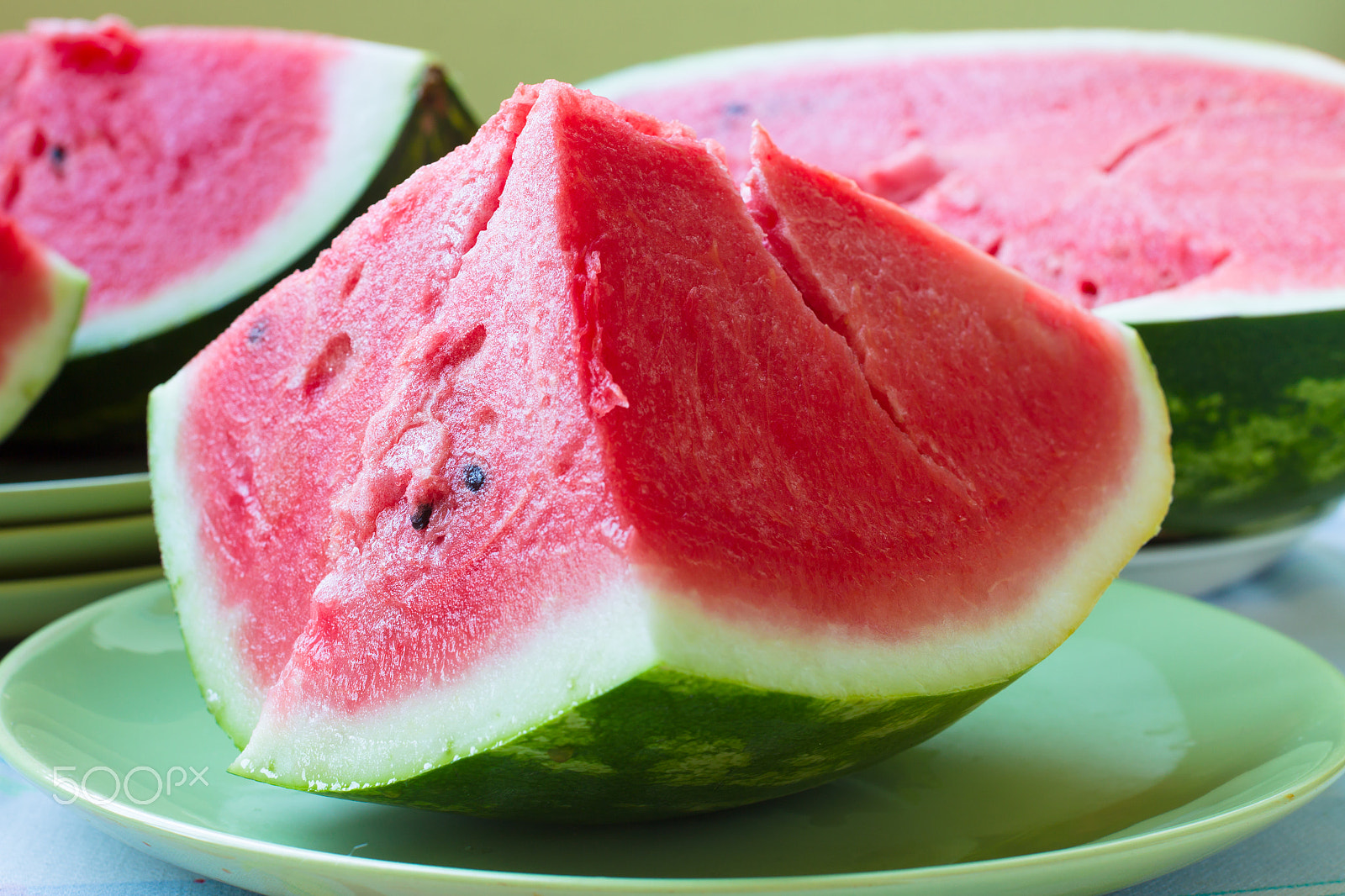 Canon EOS-1D Mark IV sample photo. A piece of juicy ripe watermelon with fleshy pink flesh on a lig photography