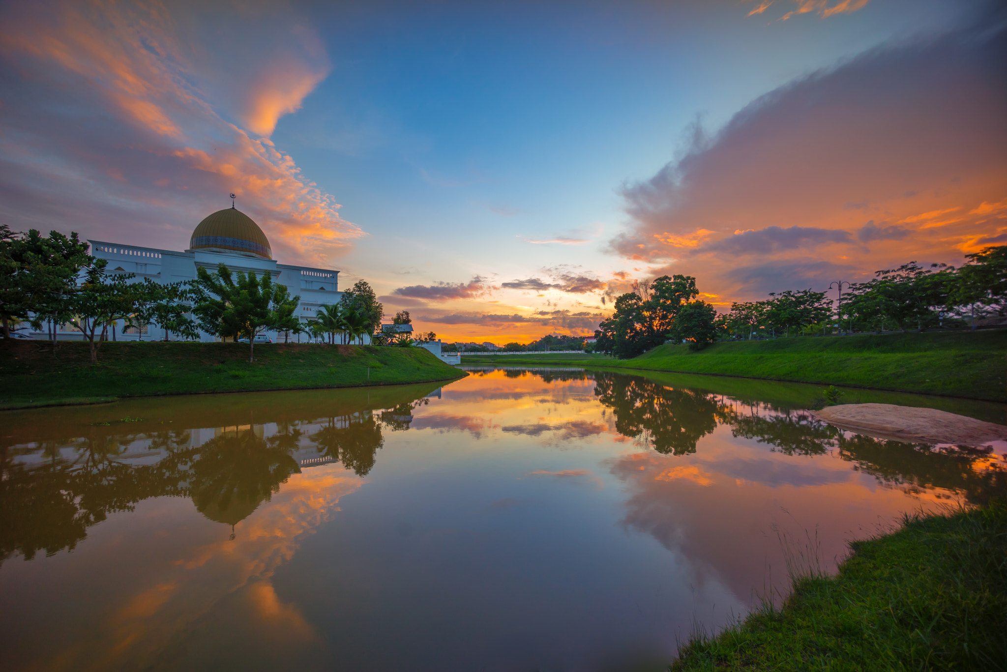 Sony a7R + Sony E 10-18mm F4 OSS sample photo. Dramatic sunset sky over a mosque photography
