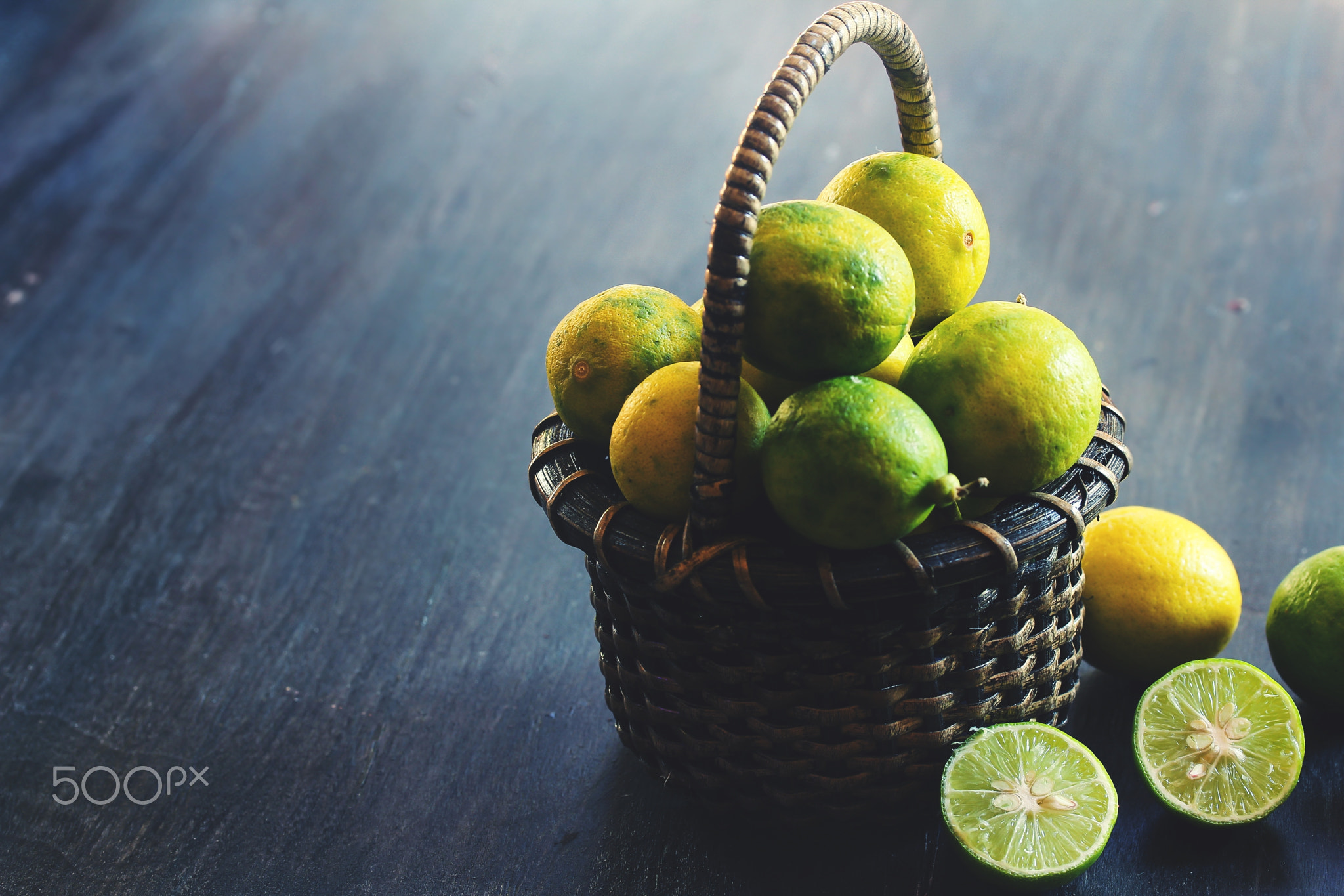 Organic Key Limes in a basket, selective focus