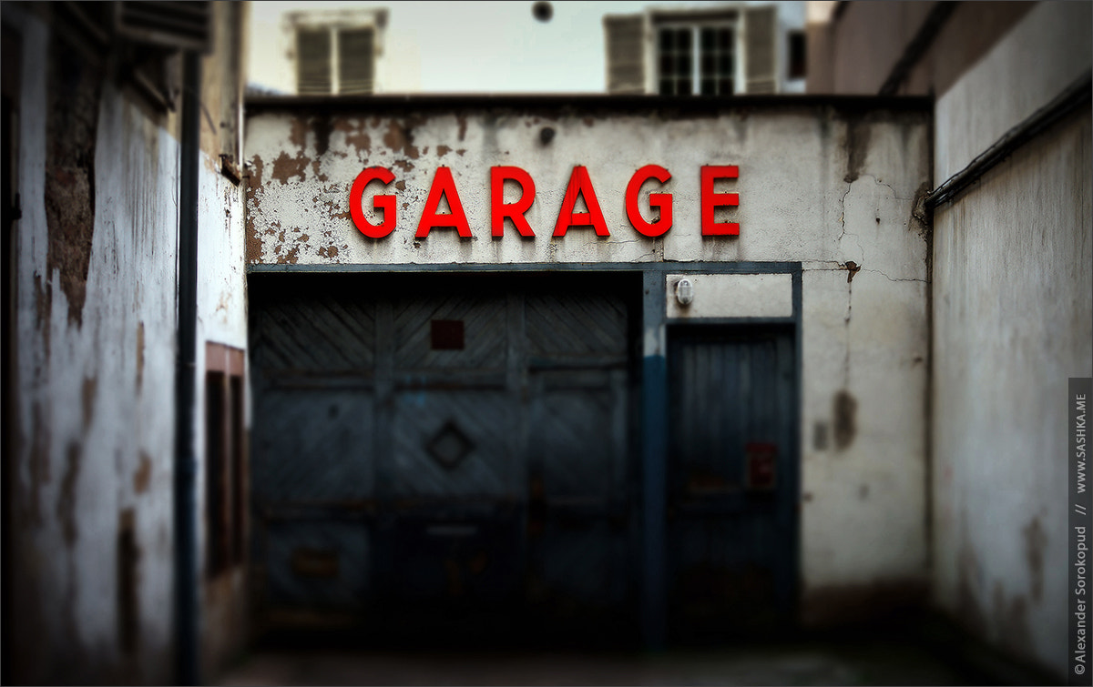 Sony a99 II sample photo. Old abandoned garage with red sign photography