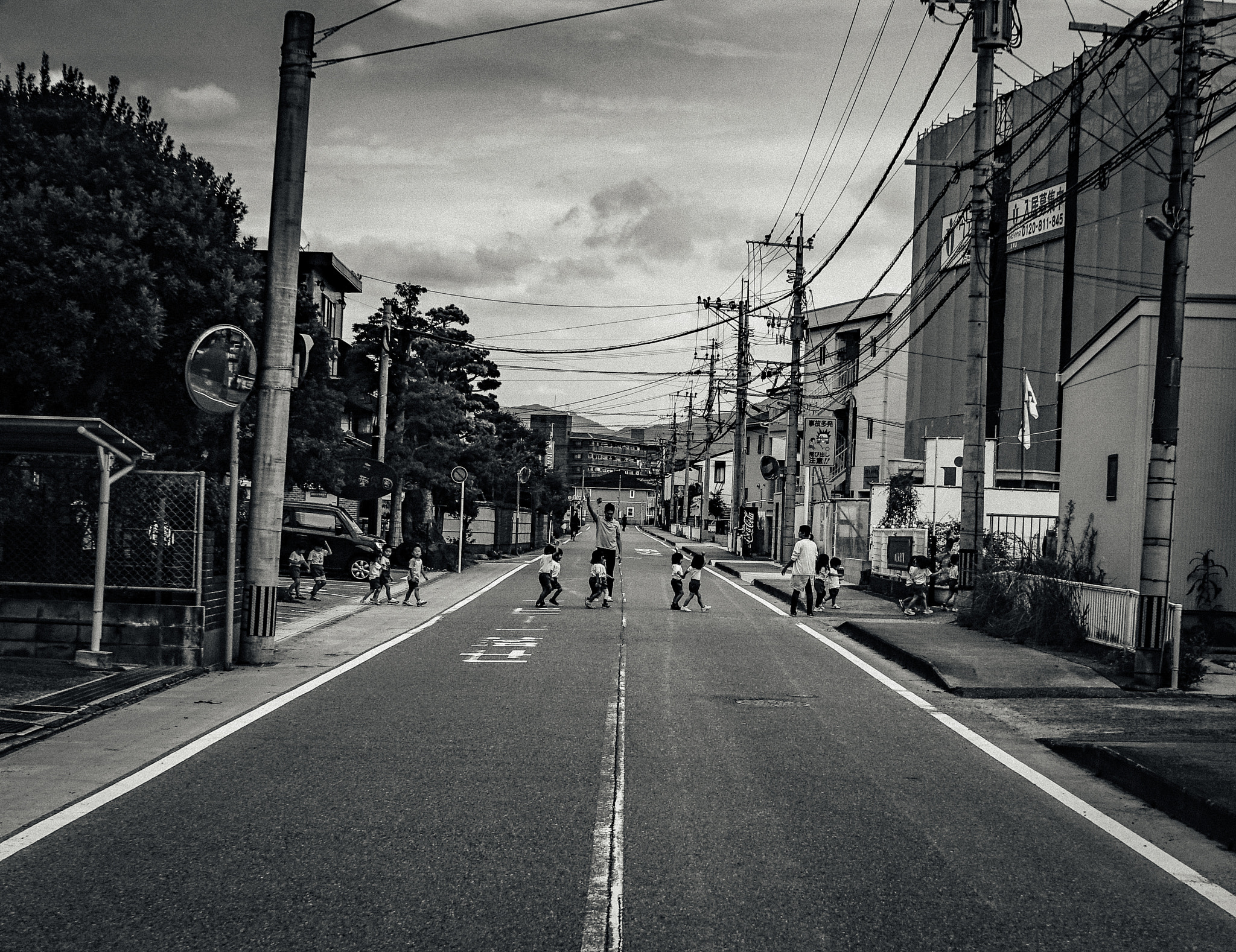 Sony a7S sample photo. Japanese teacher helping kids cross the road photography