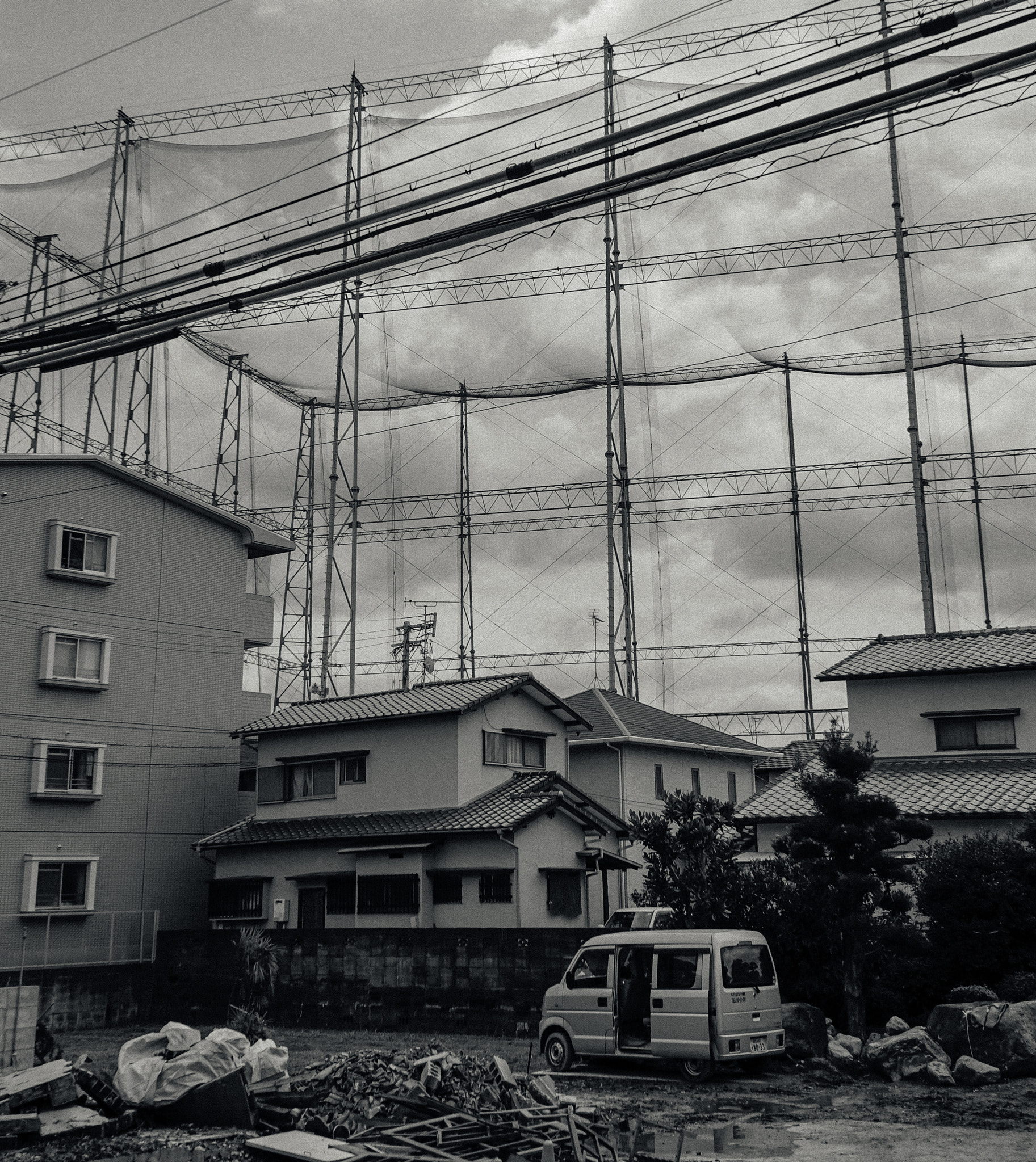 Sony a7S + Sony FE 28-70mm F3.5-5.6 OSS sample photo. Small houses in front of japanese stadium photography