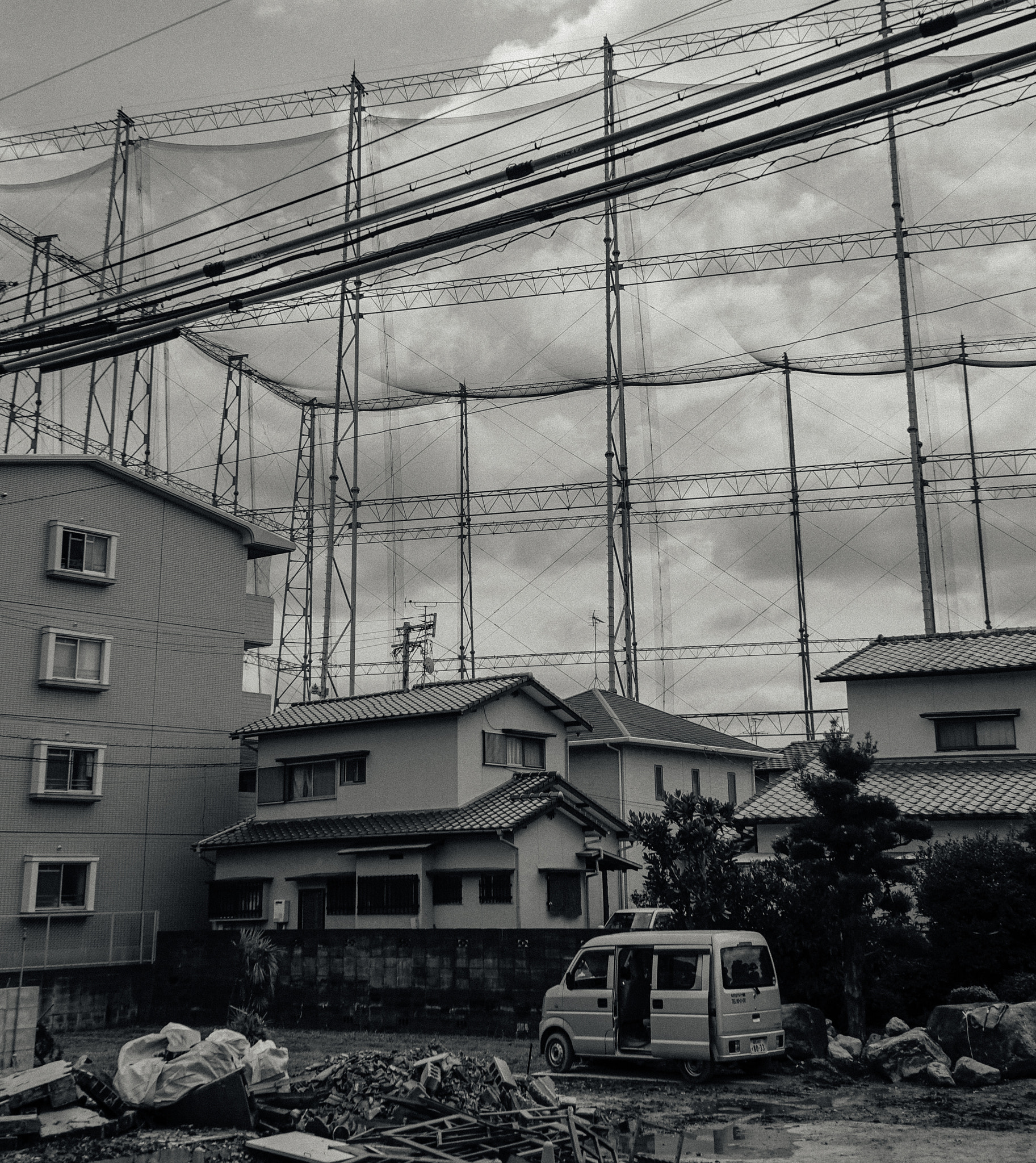 Sony a7S sample photo. Small houses in front of japanese stadium photography