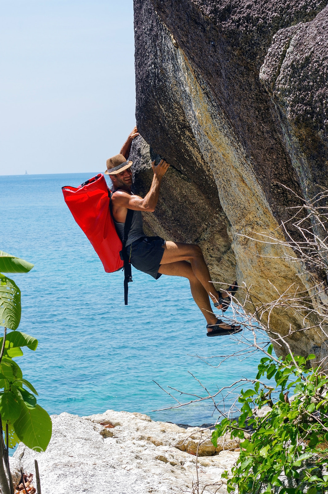 Pentax K-3 + Pentax smc DA* 55mm F1.4 SDM sample photo. Strong and happy man climbing on high rock over the sea with a h photography