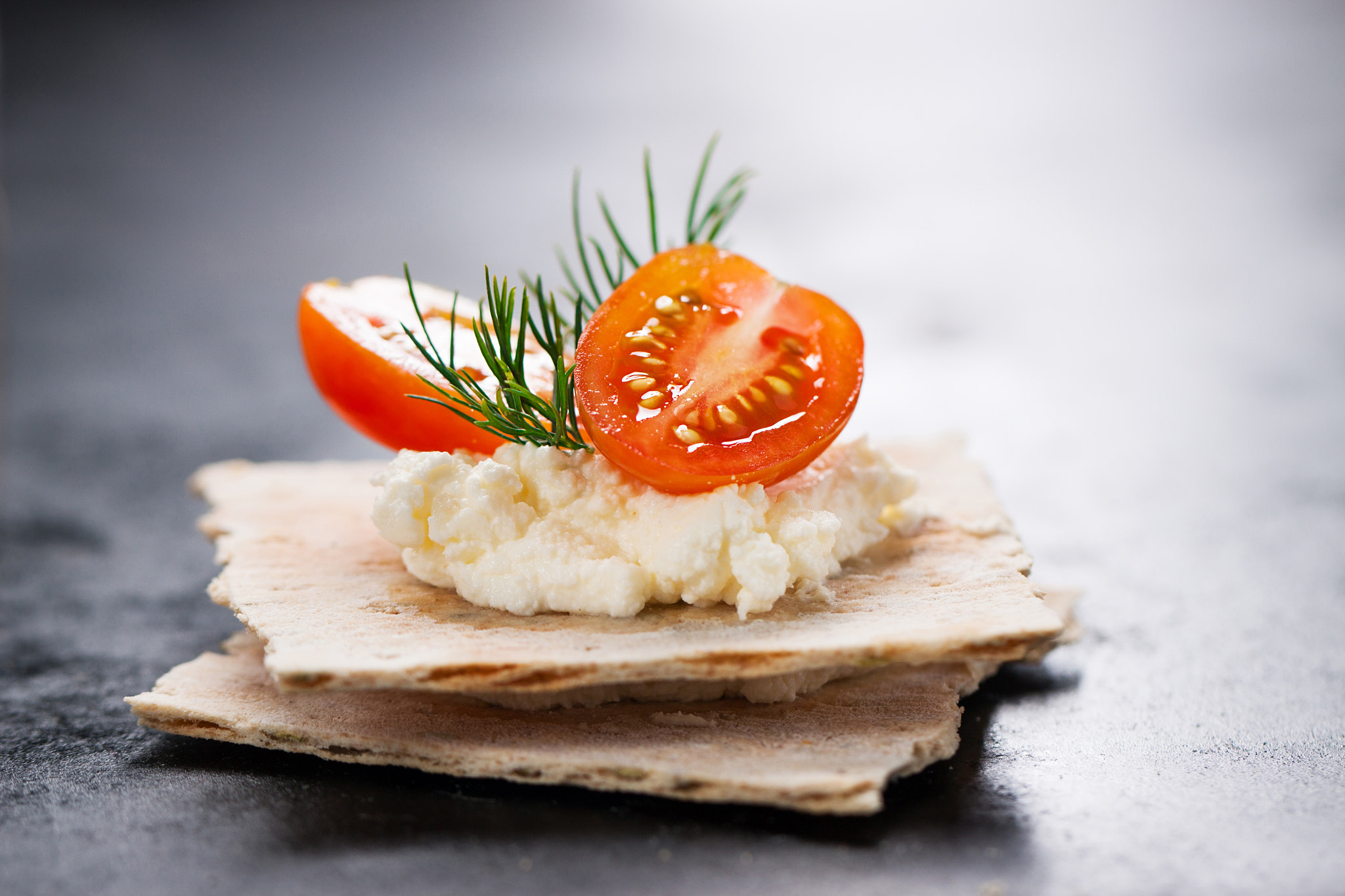 Canon EOS 50D + Canon EF 100mm F2.8L Macro IS USM sample photo. Appetizer canape with cherry tomato, cheese and dill on a small loaf of bread, closeup photography