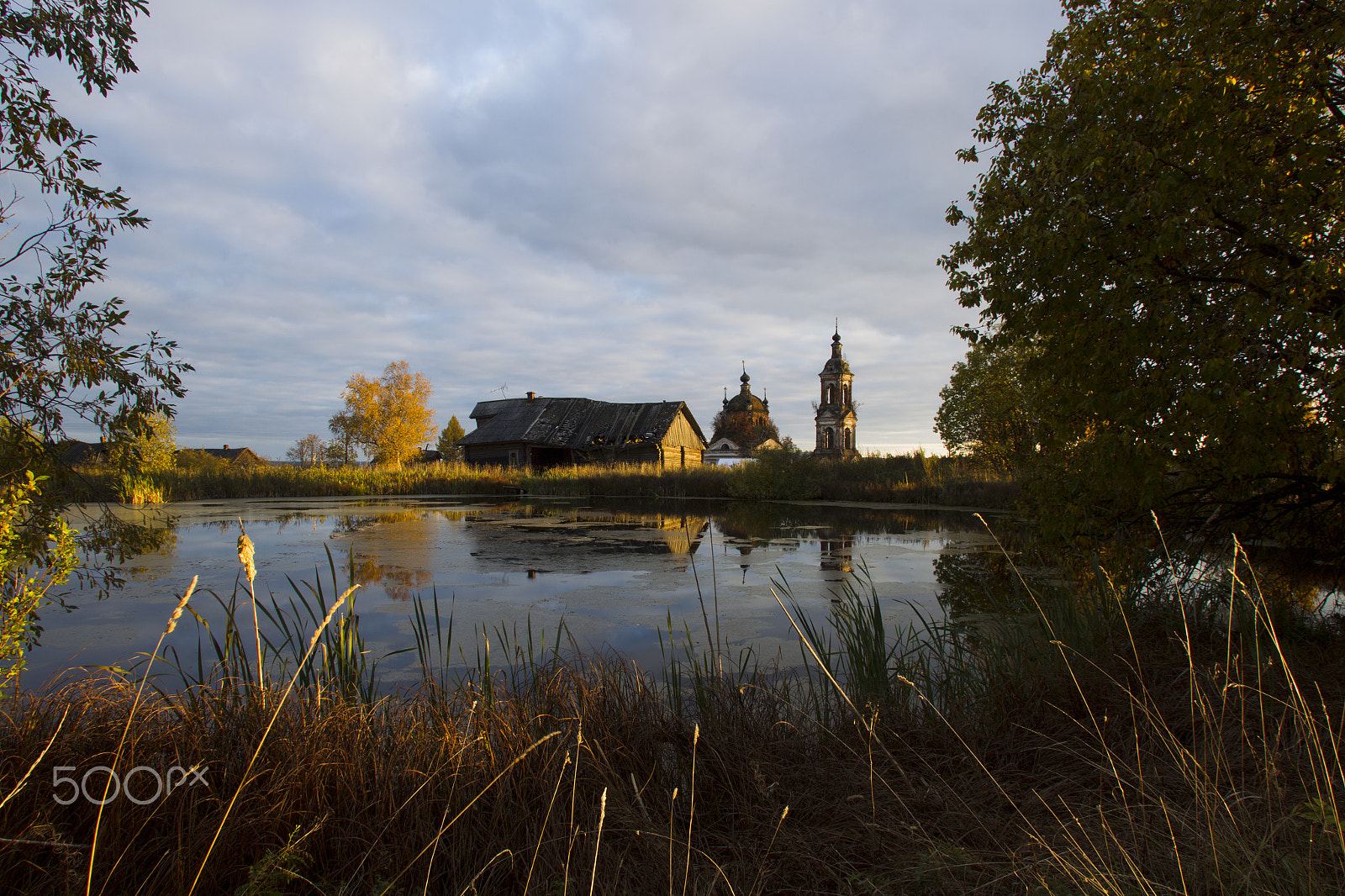 Canon EF 17-35mm f/2.8L sample photo. Autumn landscape with a pond, house and church photography