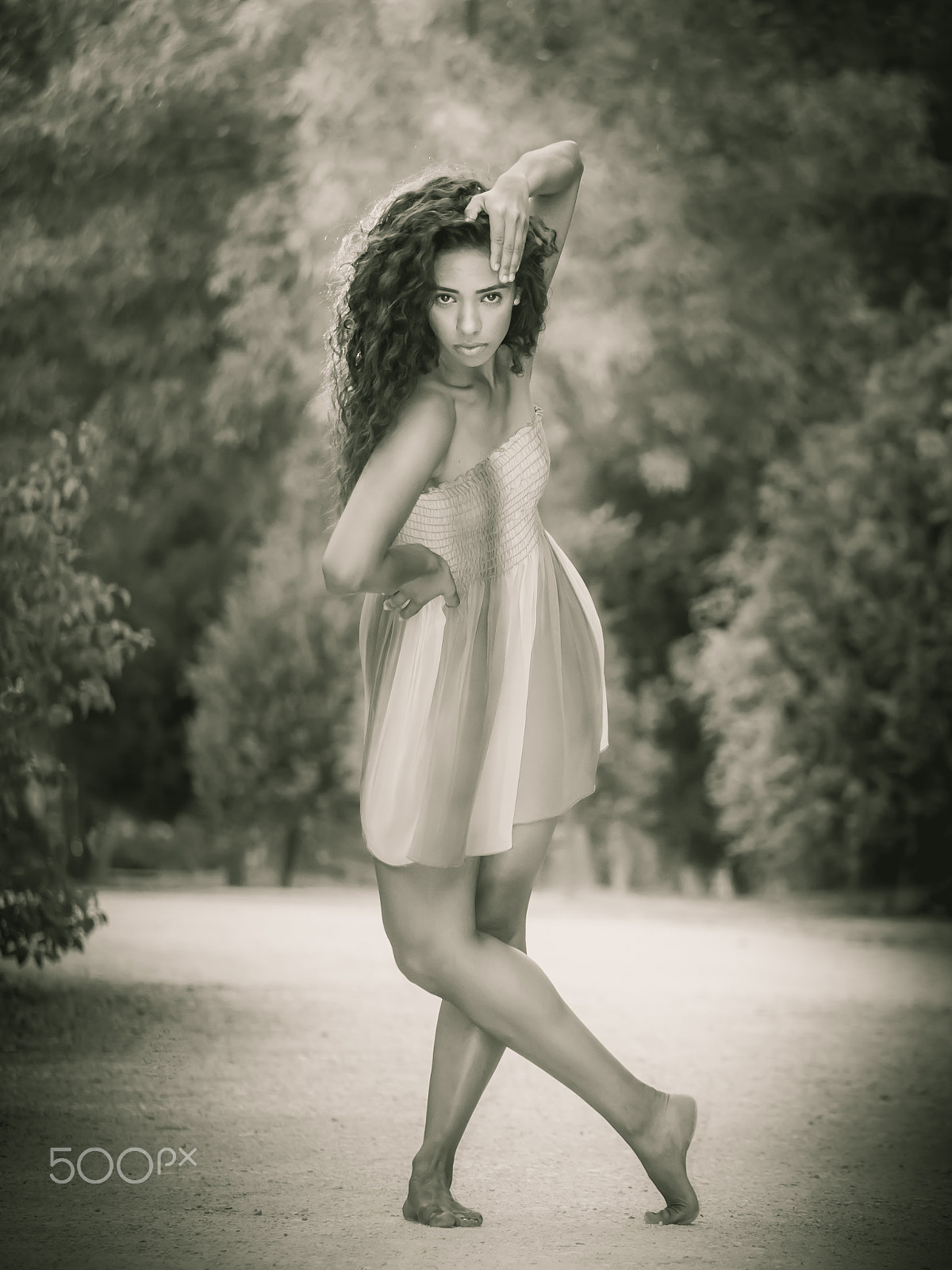 Panasonic Lumix DMC-GH3 sample photo. Dancer posing on dirt road with vegetation monochrome photography