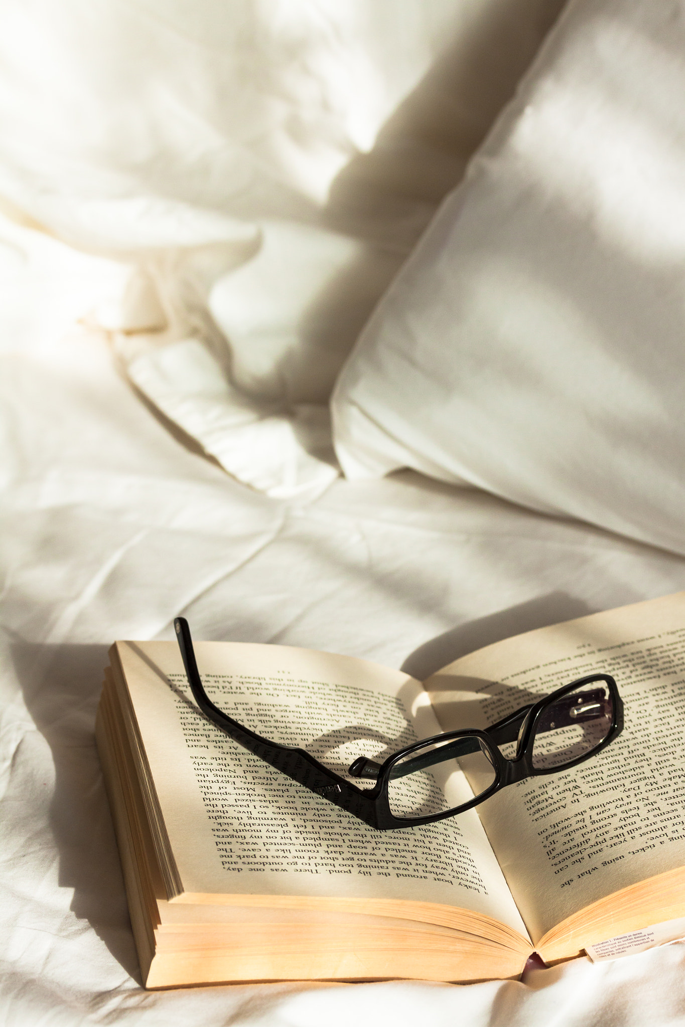 Canon EF-S 60mm F2.8 Macro USM sample photo. Glasses resting on a book on an unmade bed lit by morning sunshine photography