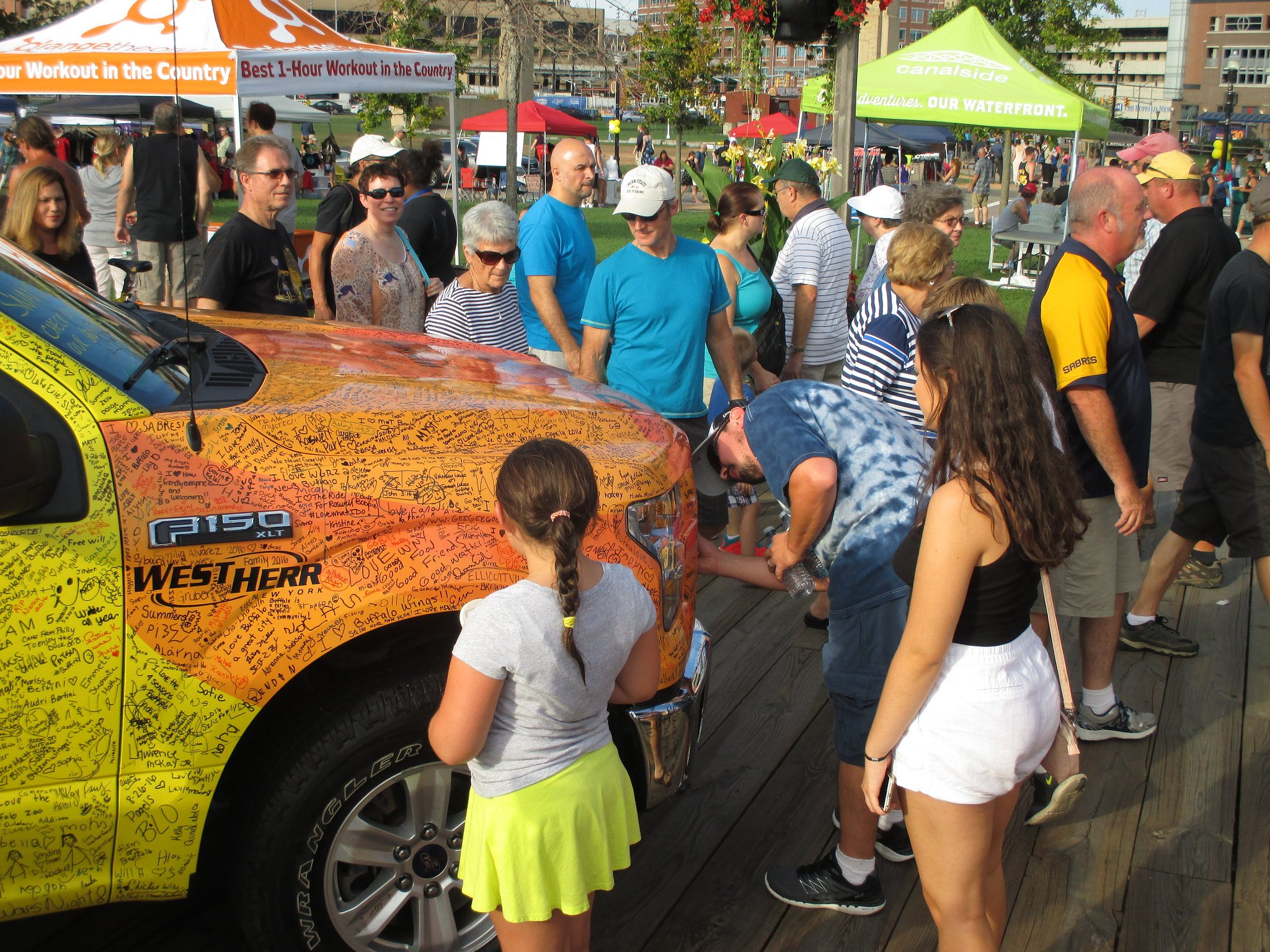 Canon PowerShot ELPH 135 (IXUS 145 / IXY 120) sample photo. People signing the duck truck photography