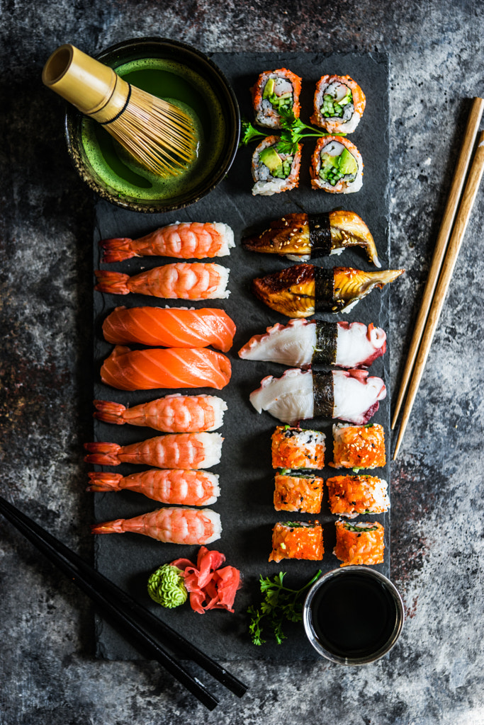 Sushi and sashimi variety on rustic background by Alena Haurylik on 500px.com