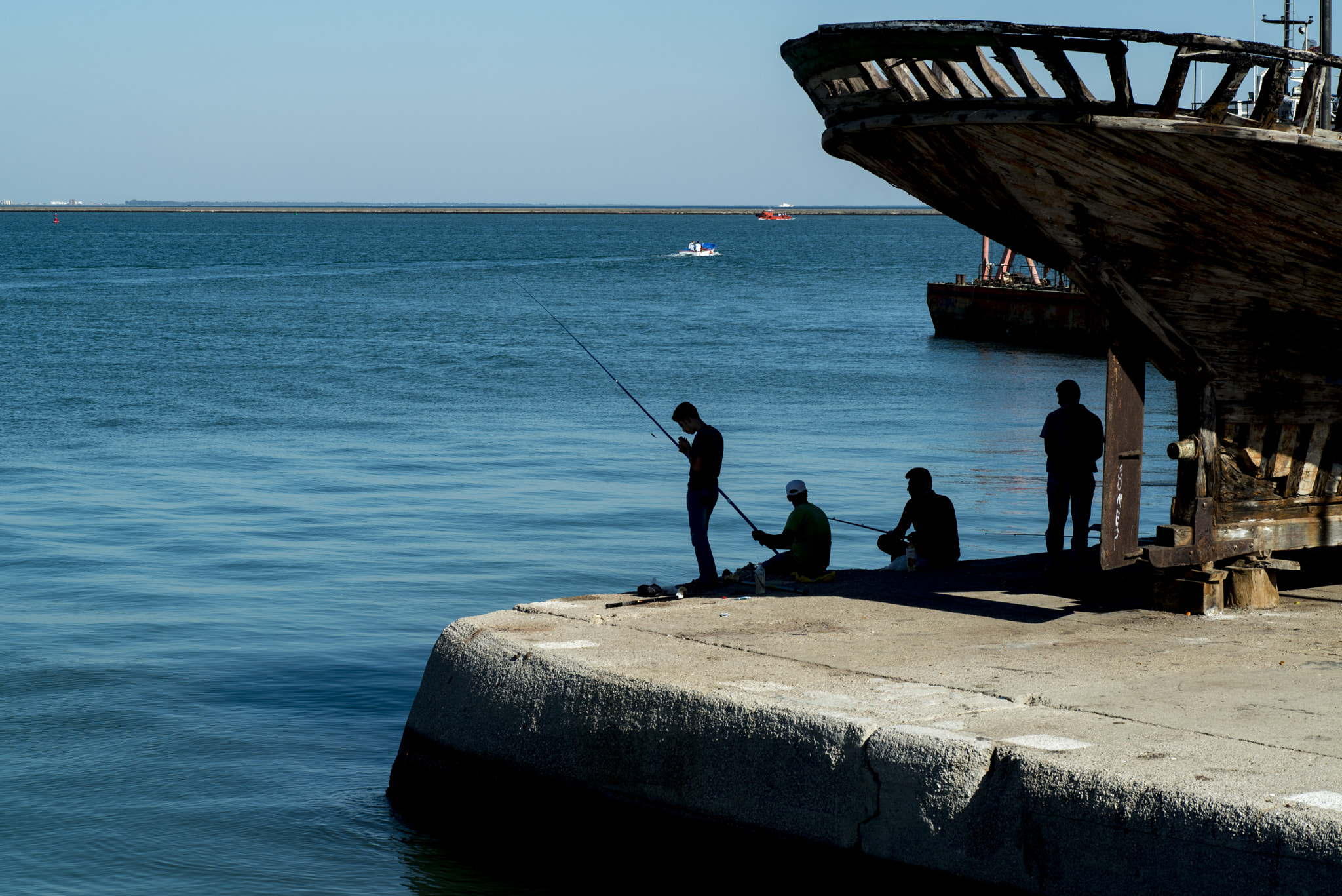 Nikon D800E + Tamron SP 90mm F2.8 Di VC USD 1:1 Macro sample photo. Silhouette of fishermen at harbour photography