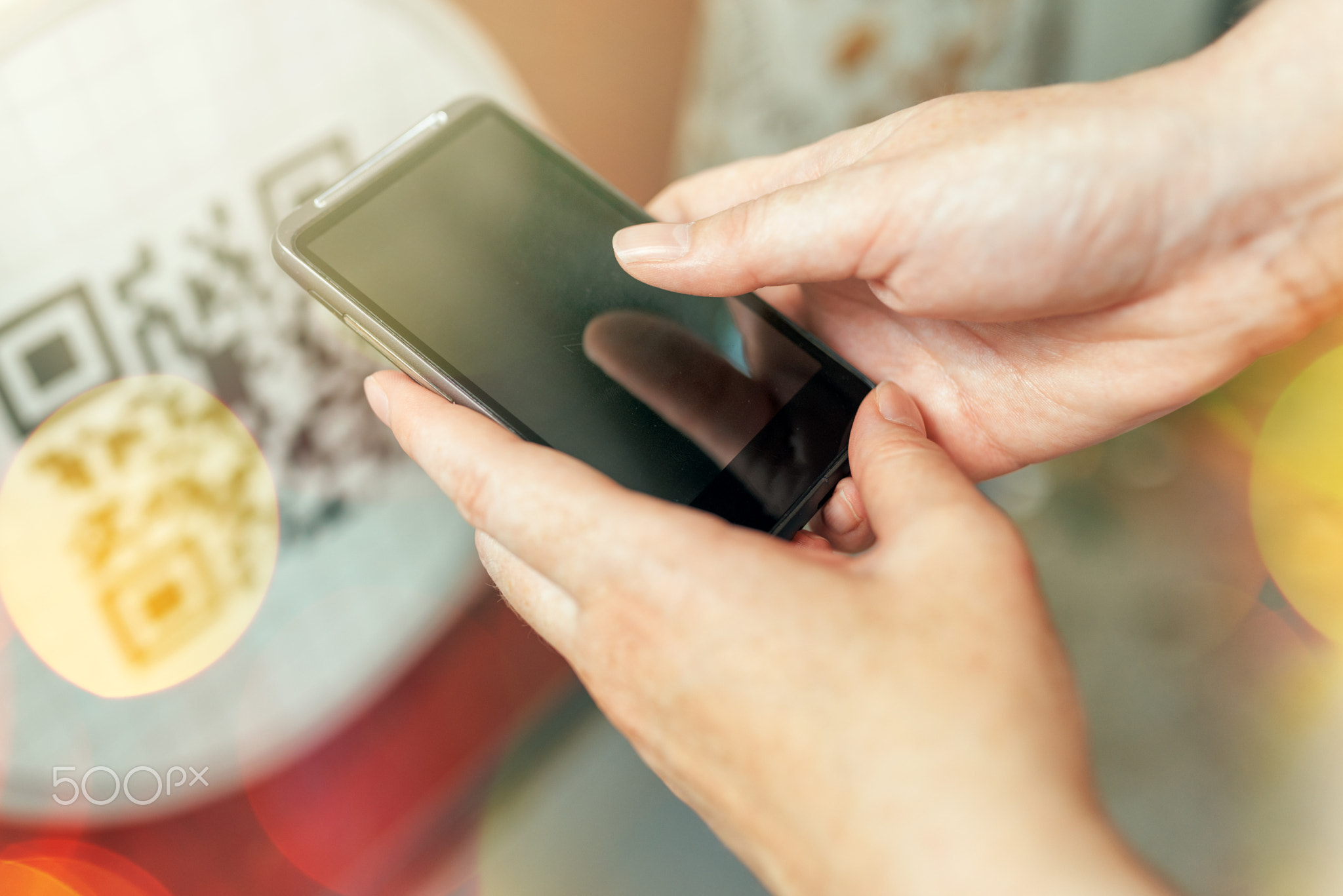 Woman scanning QR code with smartphone