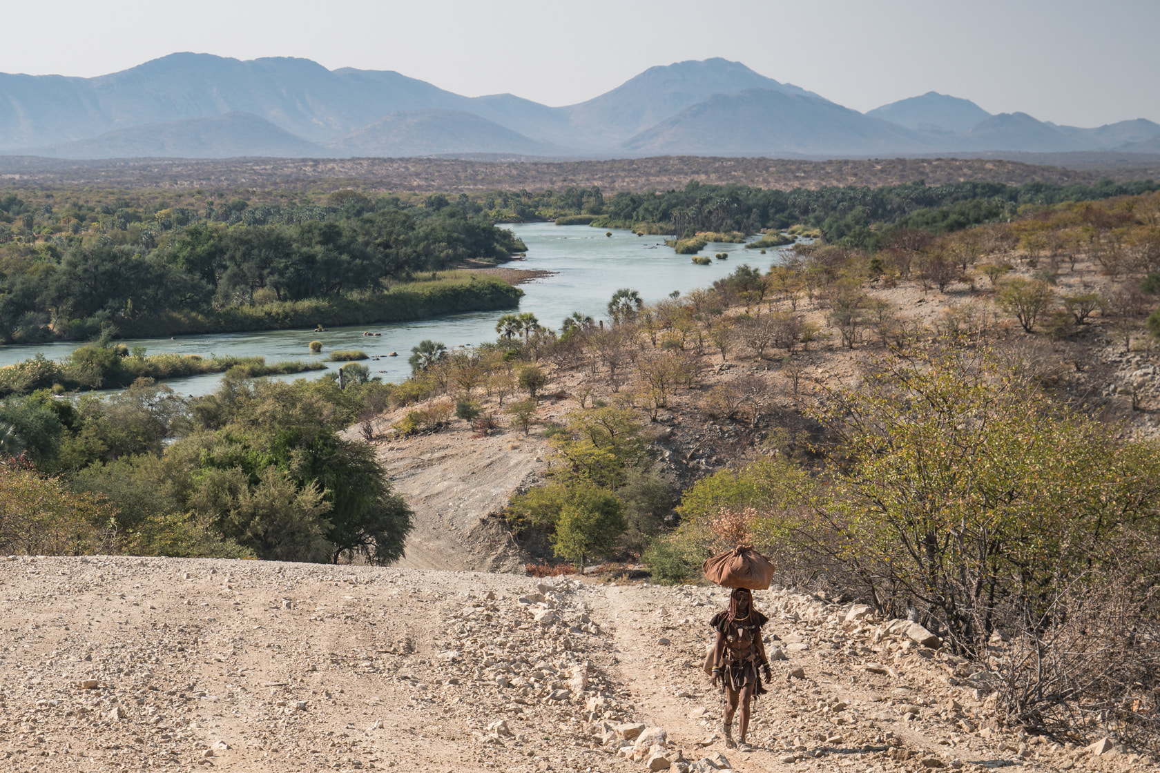 Sony a6300 + Sony E 18-200mm F3.5-6.3 OSS sample photo. Carrying water, kunene river, namibia photography