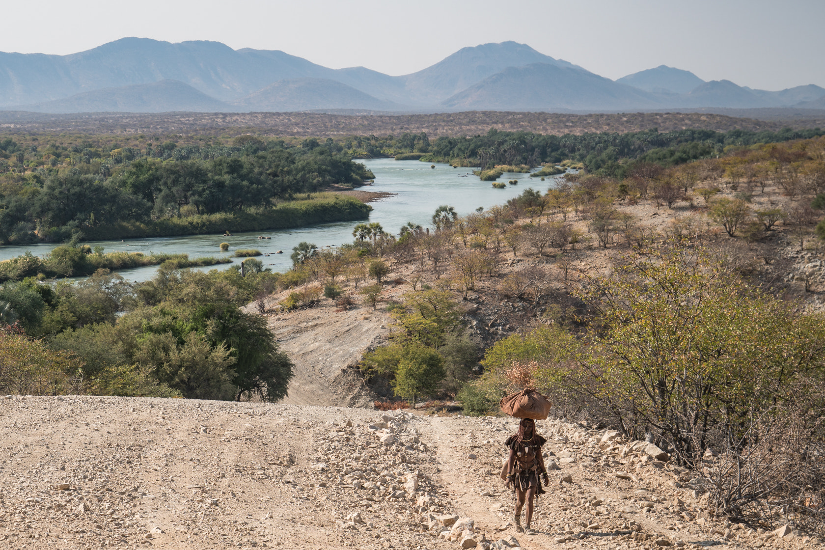 Sony E 18-200mm F3.5-6.3 OSS sample photo. Carrying water, kunene river, namibia photography