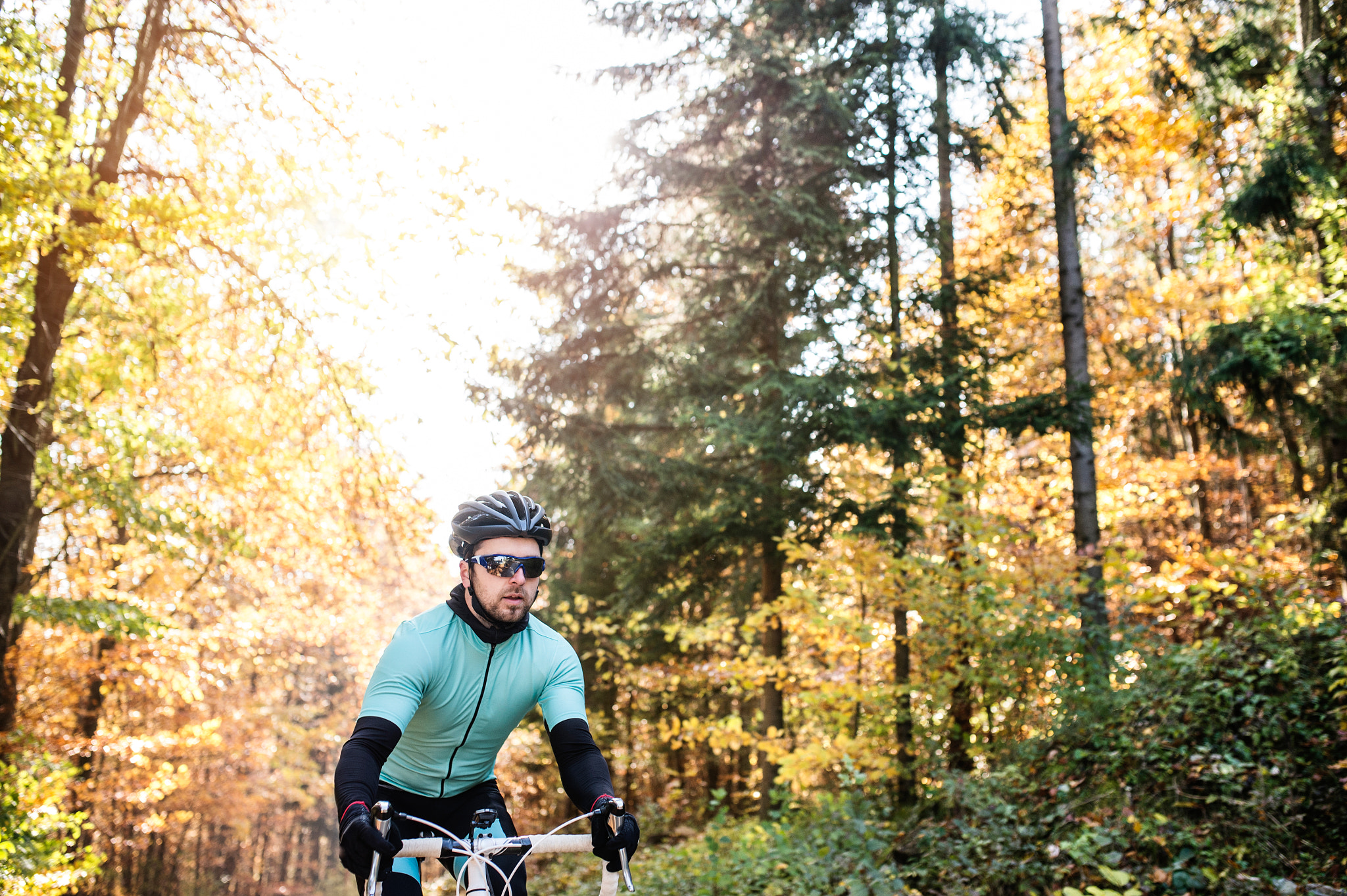 Nikon D4S sample photo. Young sportsman riding bicycle outside in sunny autumn nature photography