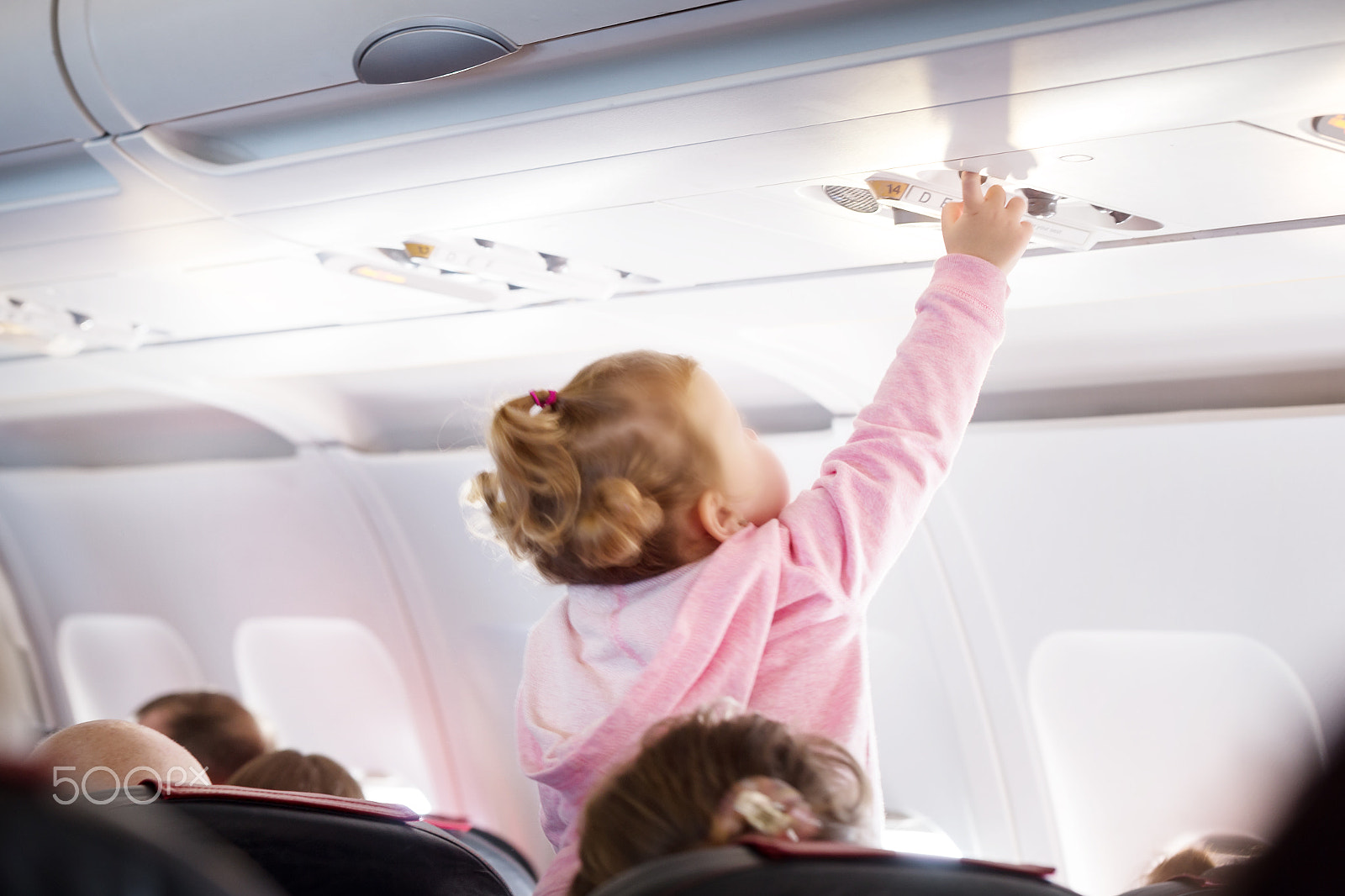 Canon EOS 6D + Canon EF 100mm F2.8L Macro IS USM sample photo. Child presses button of  luggage compartment on plane photography