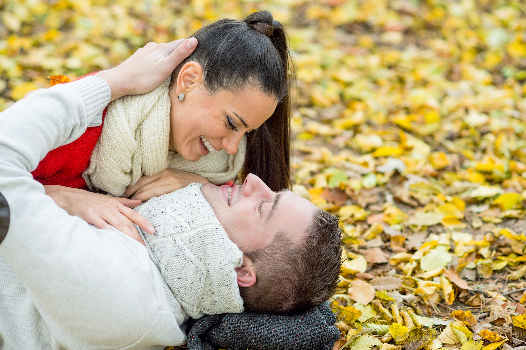 Nikon D4S + Nikon AF Nikkor 85mm F1.8D sample photo. Beautiful couple in autumn park lying on the ground photography