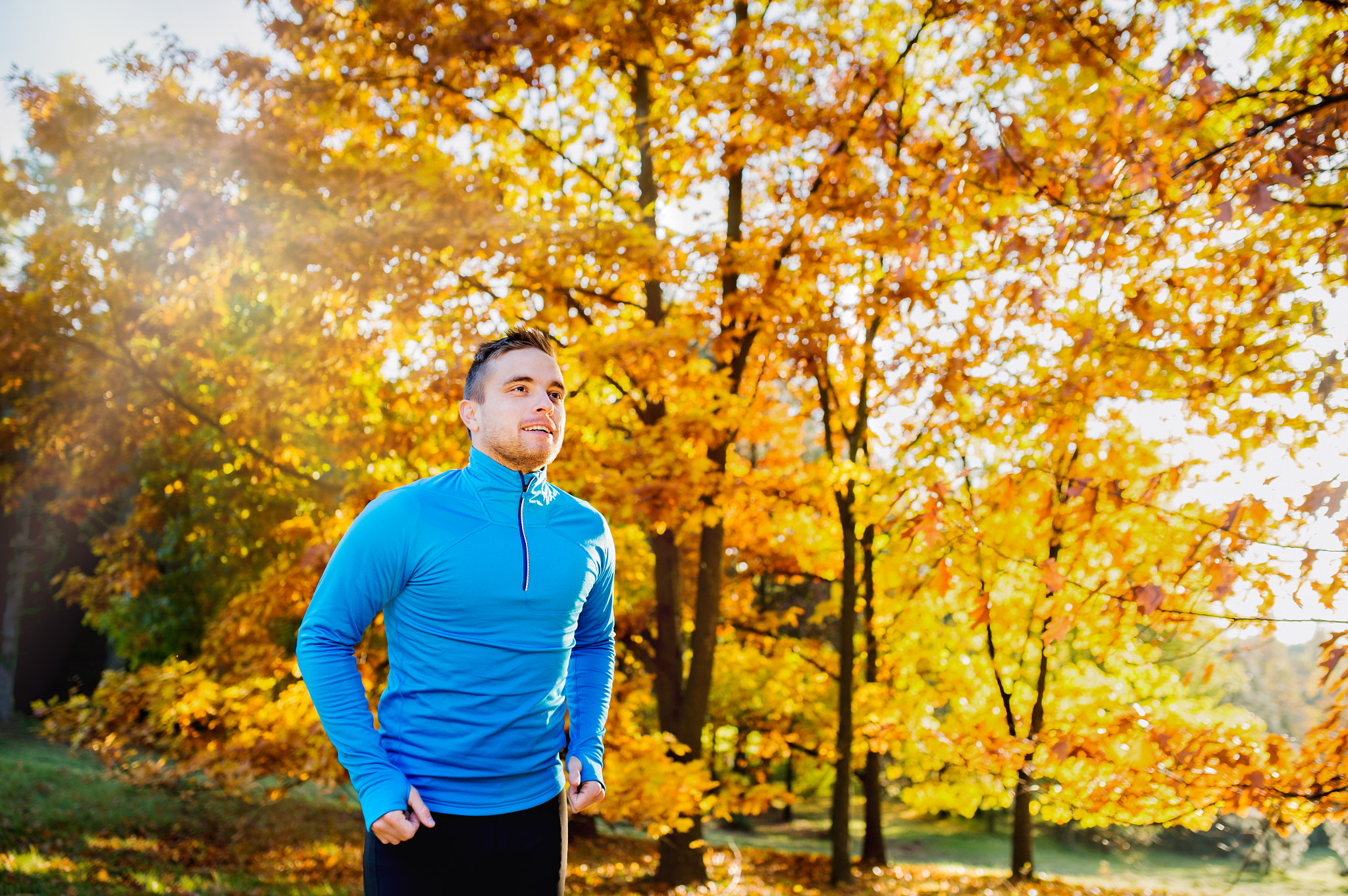 Nikon D4S + Sigma 35mm F1.4 DG HSM Art sample photo. Young handsome athlete running outside in sunny autumn nature photography