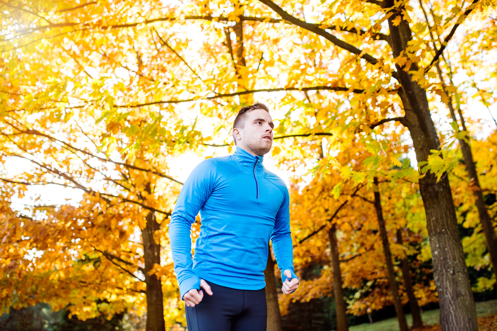 Nikon D4S + Sigma 35mm F1.4 DG HSM Art sample photo. Young handsome athlete running outside in sunny autumn nature photography