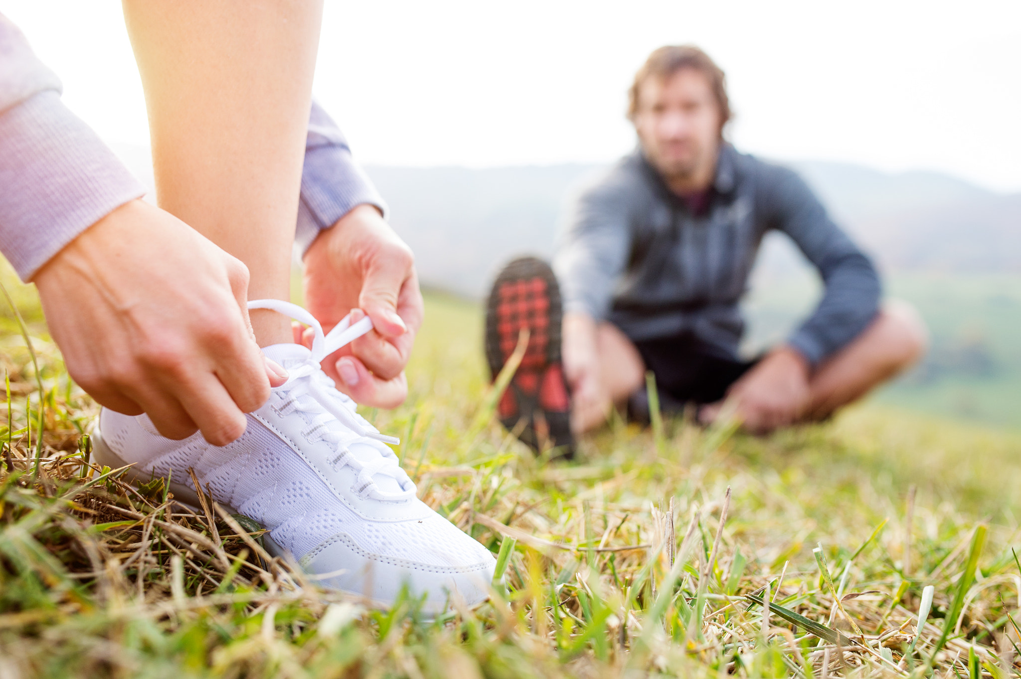 Nikon D4S + Sigma 35mm F1.4 DG HSM Art sample photo. Couple running in autumn nature, stretching, tying shoelaces photography