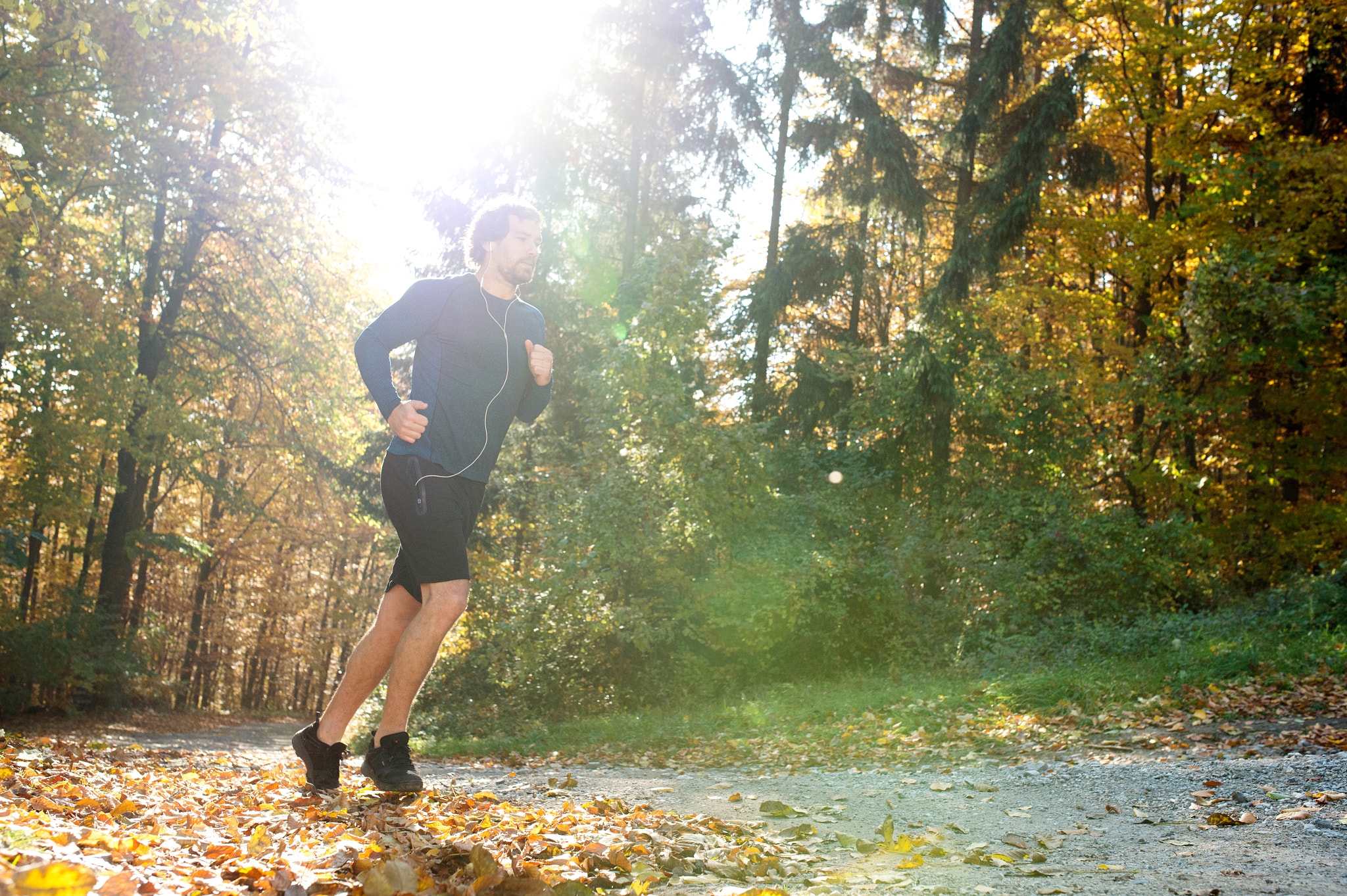 Nikon D4S + Sigma 35mm F1.4 DG HSM Art sample photo. Young handsome runner outside in sunny autumn nature photography