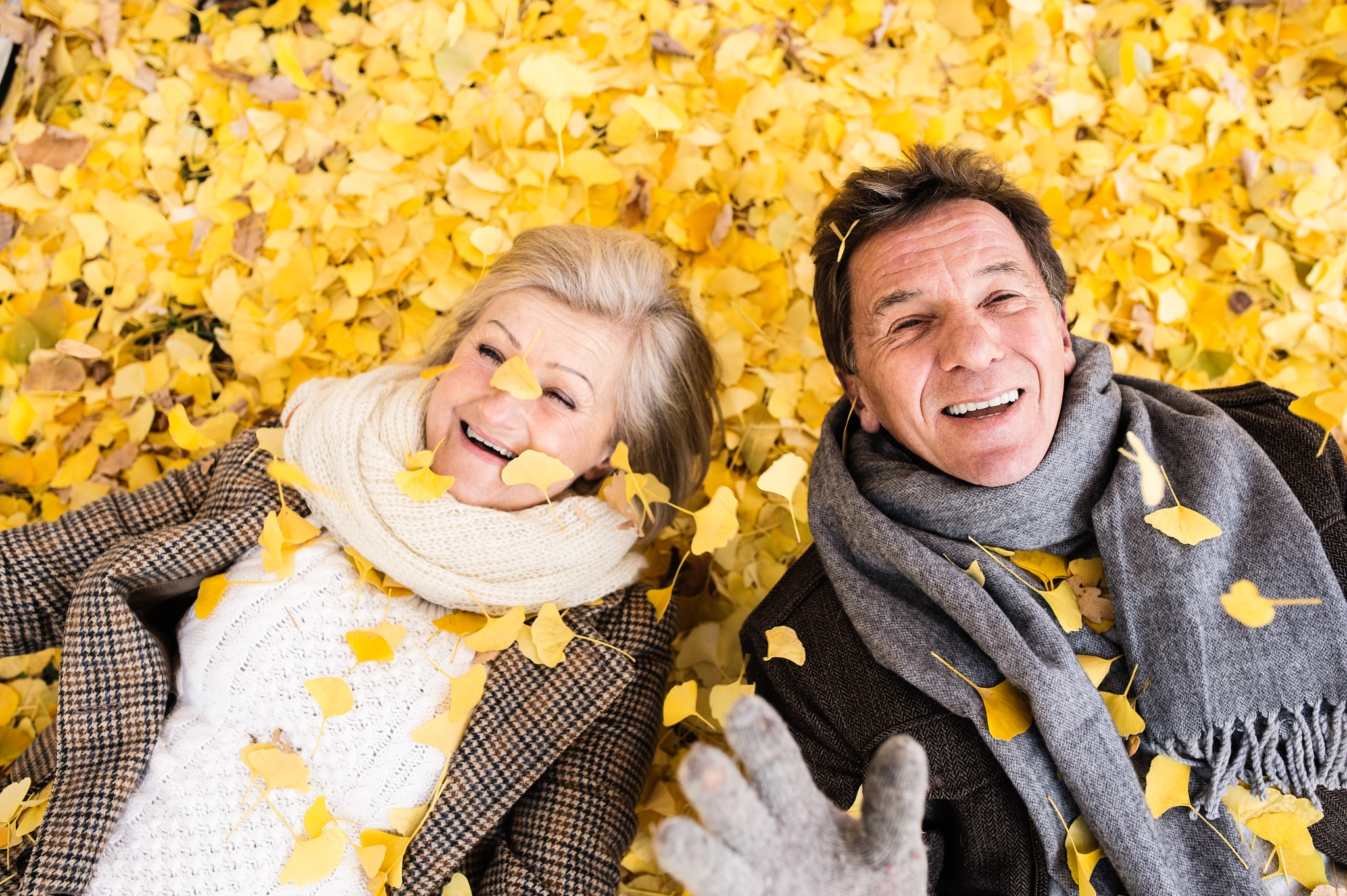 Nikon D4S + Sigma 35mm F1.4 DG HSM Art sample photo. Active senior couple in autumn park lying on the ground photography