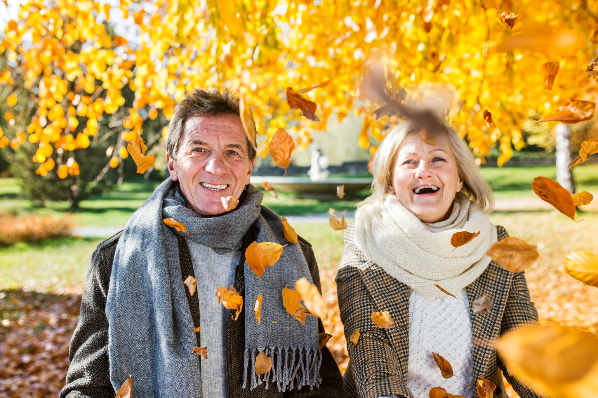 Nikon D4S + Sigma 35mm F1.4 DG HSM Art sample photo. Active senior couple in autumn park throwing leaves photography