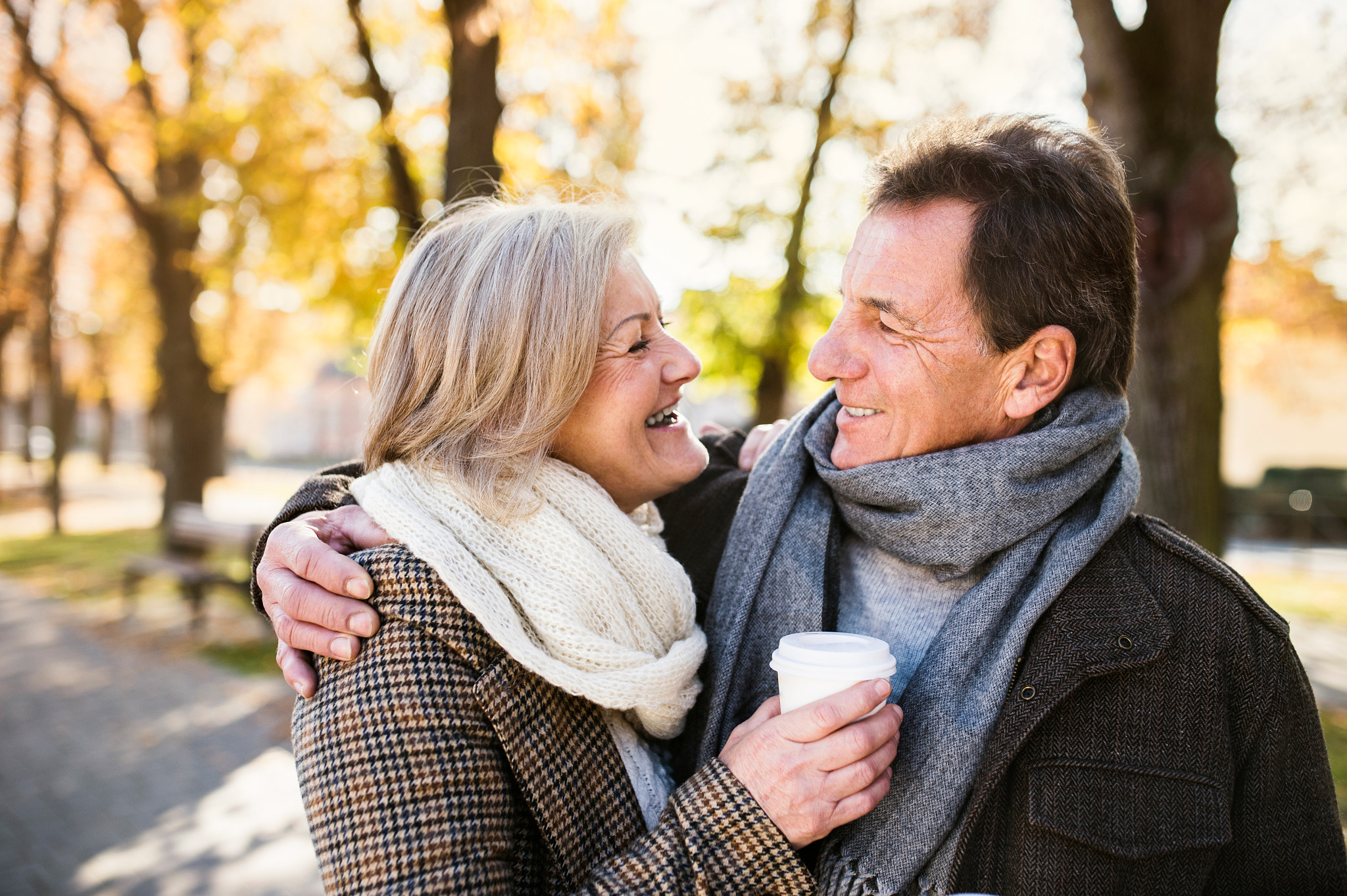 Nikon D4S + Sigma 35mm F1.4 DG HSM Art sample photo. Beautiful senior couple hugging in park, drinking coffee. autumn photography