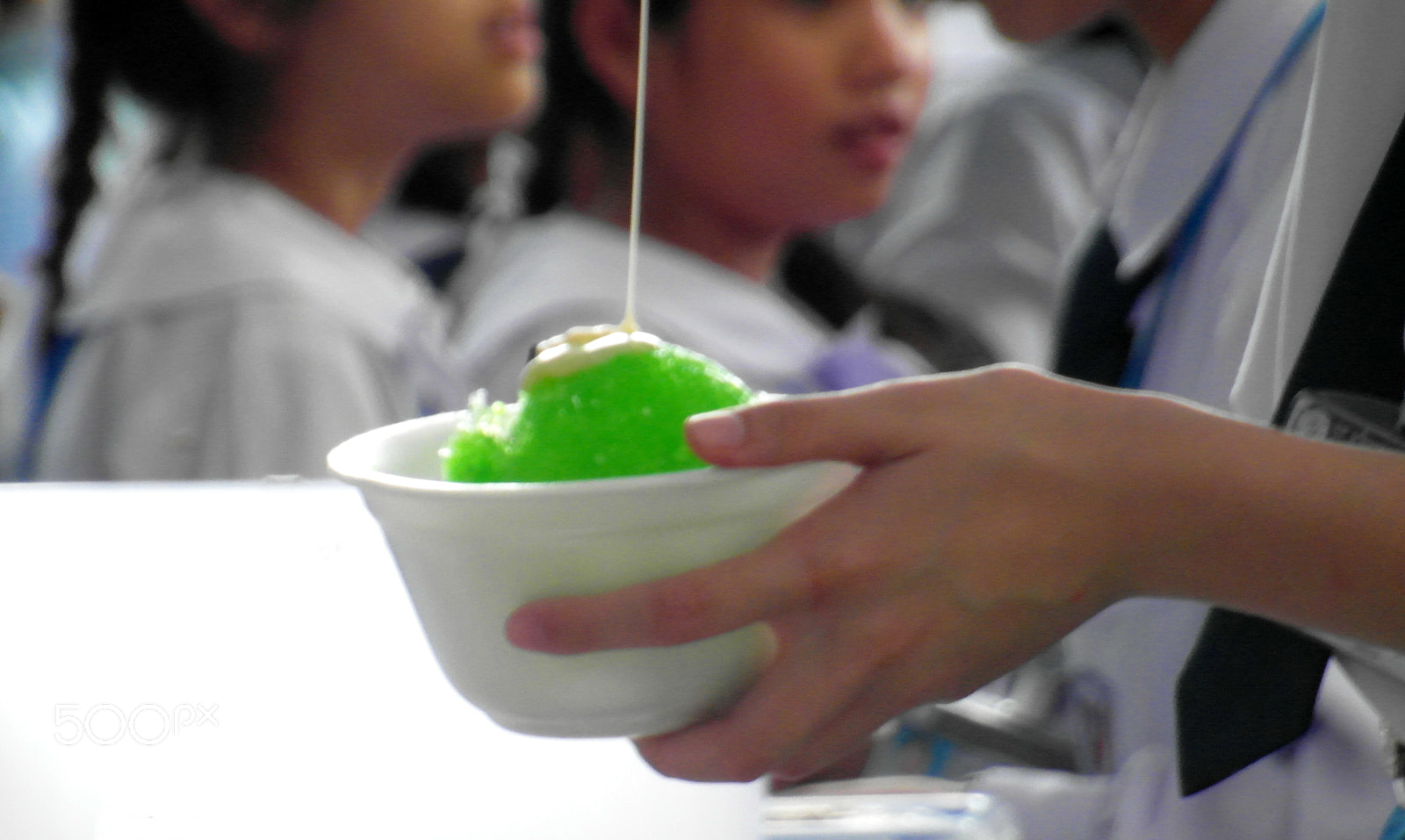 Samsung WB750 sample photo. Dripping sauce onto green iced dessert photography